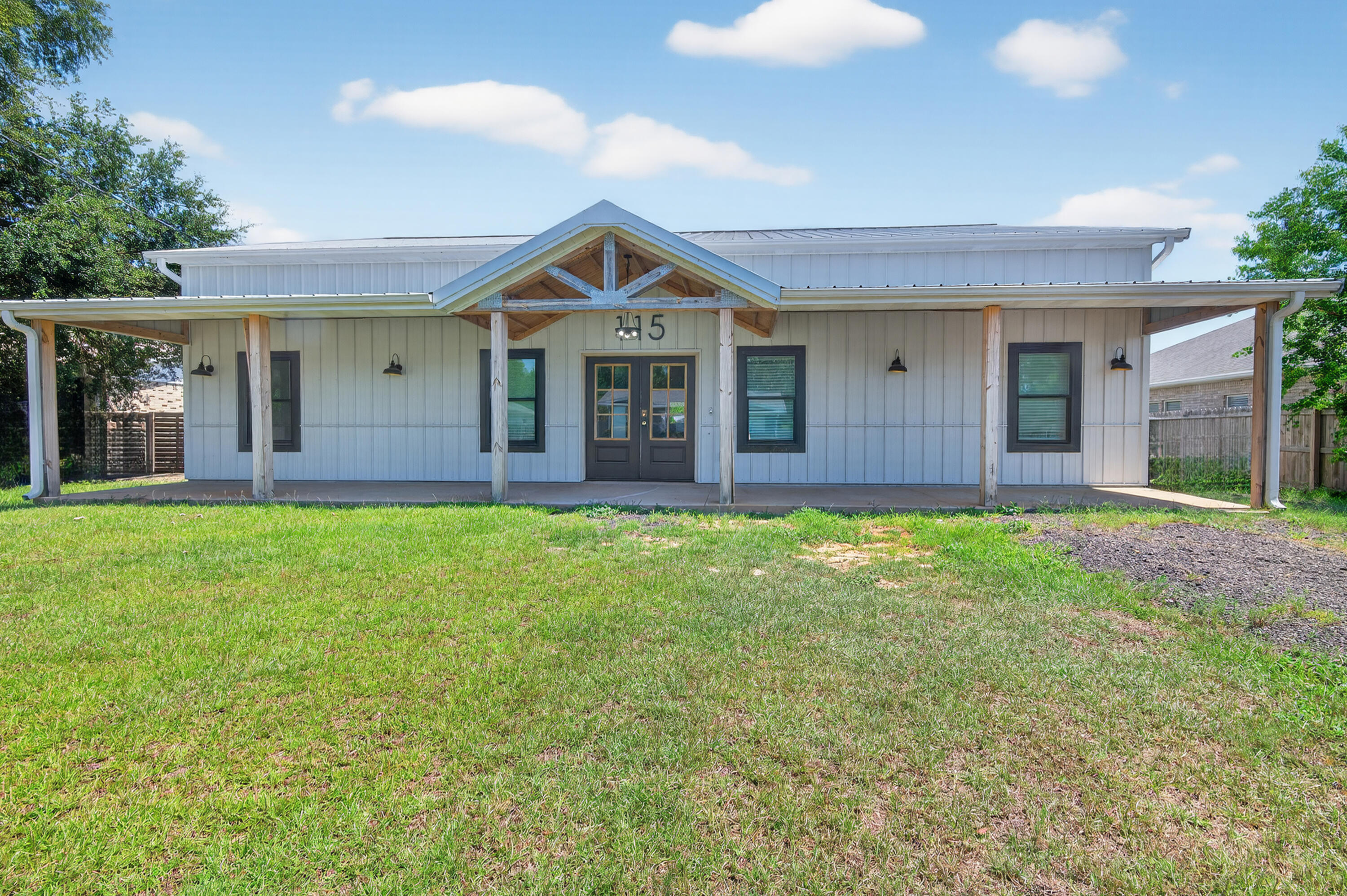 Built in 2023, this modern farmhouse offers a rare blend of style, space, and function just minutes from Hurlburt Field, local schools, shopping, and the white-sand beaches of the Emerald Coast. Designed with a ranch-style layout on the main level and a spacious loft upstairs, this 2-story home features 5 bedrooms, 3.5 bathrooms, and soaring 11-foot ceilings throughout the main floor.Enjoy bamboo flooring throughout, a bright open living area, and a well-equipped kitchen with new stainless steel appliances. The nearly half-acre lot is fully fenced and includes in-ground pool, two detached outbuildings with electric--ideal for workshops, storage, or hobby space.To help visualize this home's floor plan and to highlight its potential, virtual furnishings may have been added to photos.