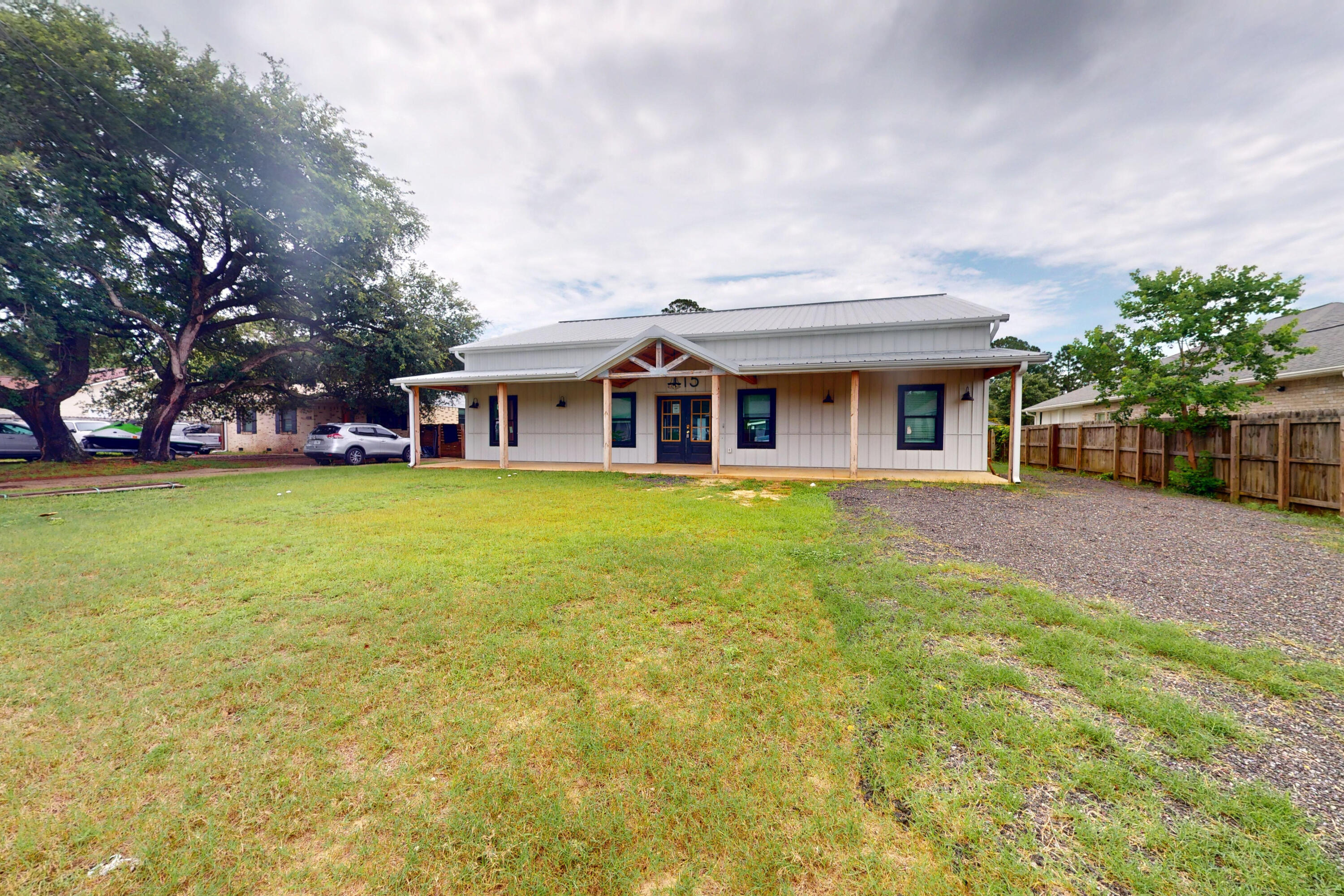 Built in 2023, this modern farmhouse offers a rare blend of style, space, and function just minutes from Hurlburt Field, local schools, shopping, and the white-sand beaches of the Emerald Coast. Designed with a ranch-style layout on the main level and a spacious loft upstairs, this 2-story home features 5 bedrooms, 3.5 bathrooms, and soaring 11-foot ceilings throughout the main floor.Enjoy bamboo flooring throughout, a bright open living area, and a well-equipped kitchen with new stainless steel appliances. The nearly half-acre lot is fully fenced and includes two detached outbuildings with electric--ideal for workshops, storage, or hobby space. With durable metal roofing and siding, this home is built for long-lasting performance.