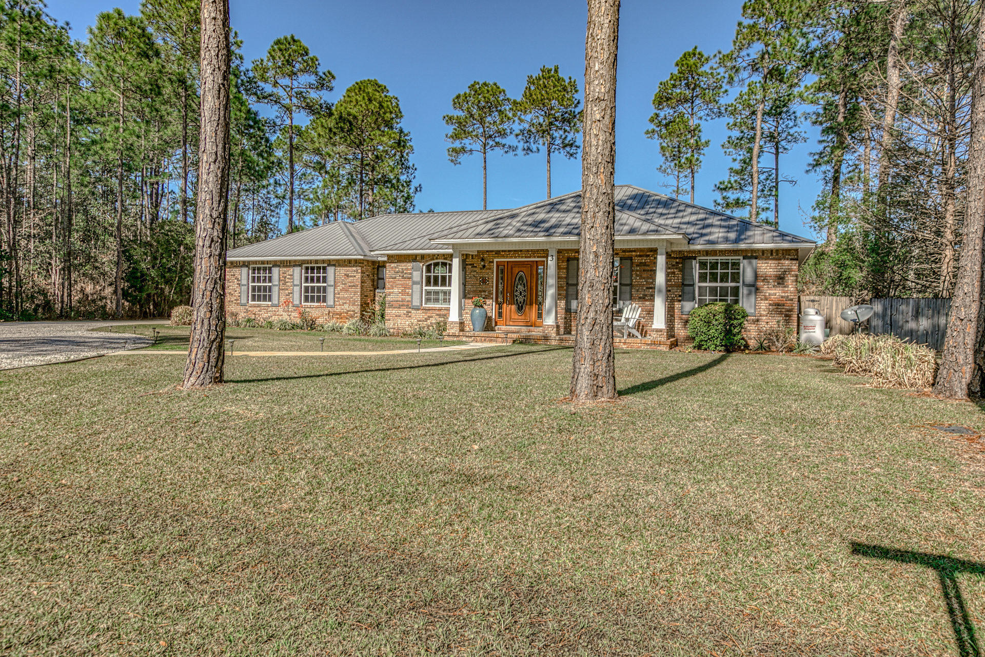 Located on 1/2 an acre with a swimming pool! This immaculate 3 Bedroom 2 Bath home is located in the up and coming Lagrange Shores neighborhood. With beautiful landscaping this home has amazing curb appeal. The kitchen includes stainless steel appliances, slate tile, and a breakfast bar overlooking the main living area. Enjoy entertaining in the large living area around the fireplace with access to the screened in back porch and beautiful salt water pool. The spacious master bedroom includes wood flooring and a large walk in closet. Other additions include trey ceilings, a metal roof, and a large fenced in back yard. This beautiful subdivision offers the luxury of privacy, accessibility and most importantly, no HOA fees. This home is a must see!