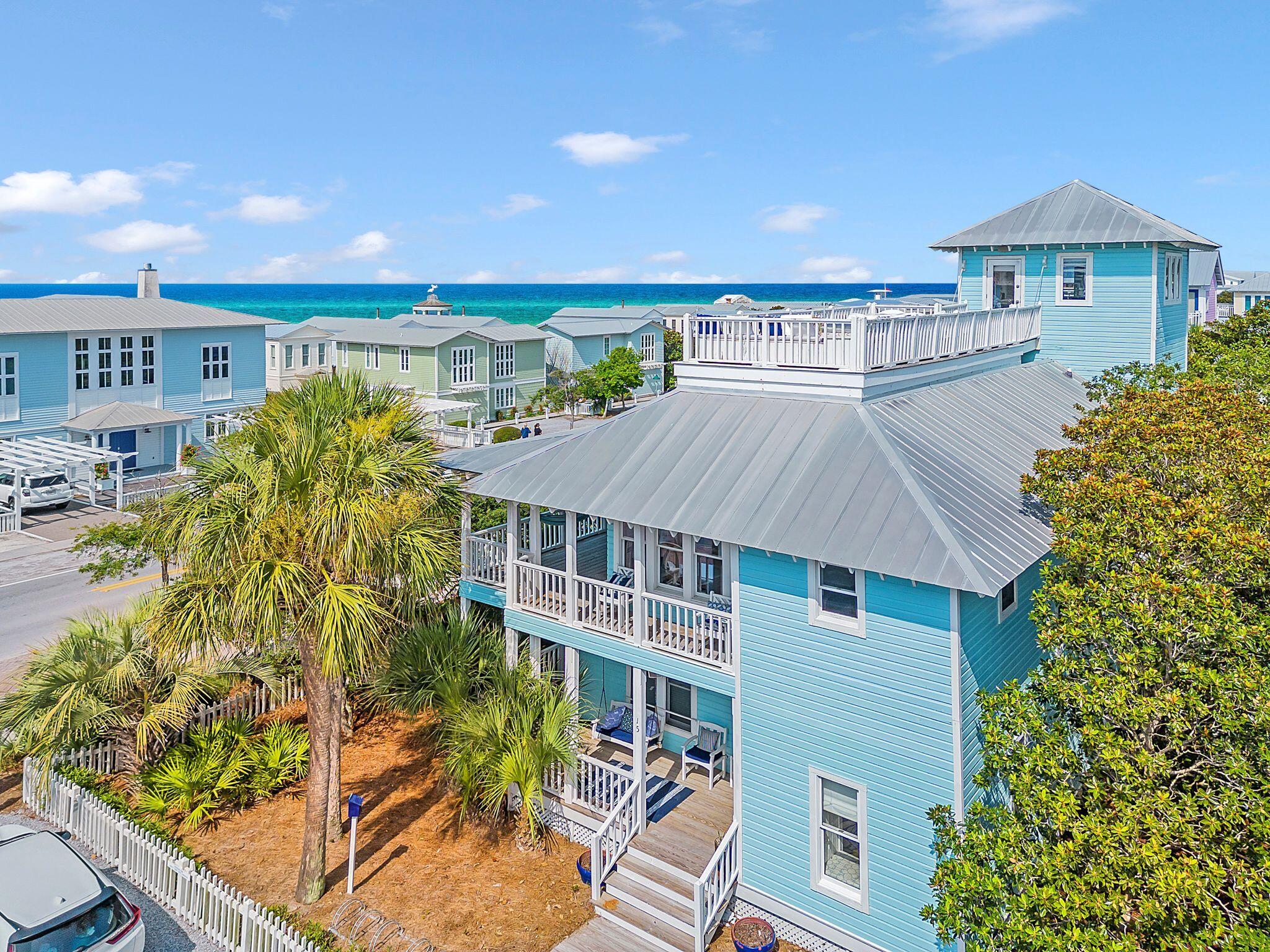 Coastal Charm awaits at this 4 bedroom 4 bath 2,774 SF Seaside beach cottage located directly on 30A and the corner of W Ruskin St. just one block from the Seaside town center and across the street from one of Seaside's nine private beach accesses. This home offers wood flooring and ceiling and white shiplap walls throughout and an abundance of porch space on each level allowing you to take advantage of Florida beach living.  This beach abode has a reverse floor plan with the main living area on the second floor allowing you to enjoy views of the gulf of Mexico better.  The first floor offers the master bedroom and master bath along with 2 additional bedrooms, each with their own ensuite.  The second floor boasts a soaring vaulted white shiplap ceiling accented with beautiful white