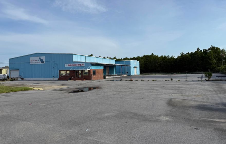 The property includes approximately 16,000 square feet split between two warehouse buildings--one around 10,000 square feet with adjoining office space and another 6,000 square feet structure. With 25-foot ceilings, a freight dock, side dock, drive-in access, and an on-site truck scale, the site is designed for efficient operations. The 2.48 acre lot is  fenced, providing secure outdoor storage or staging, and the building shell is ready for tenant improvements or owner customization. Low annual expenses and its prime location just off Highway 98 make it an attractive option for logistics, warehousing, light manufacturing, or investment. This is a flexible property with strong infrastructure and potential for both users and investors.