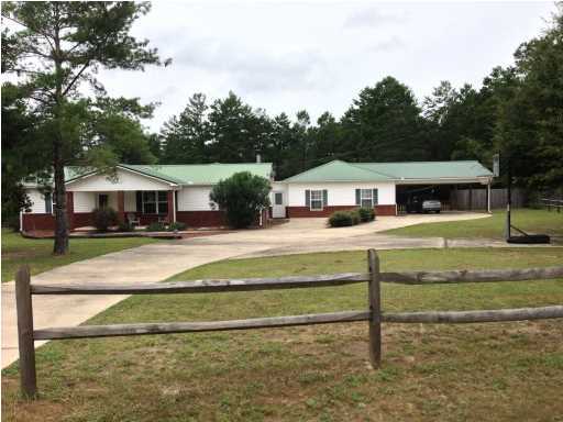 This beautiful home has the look of new home with its open, split bedroom floor plan, professional paint job and tile floors. The main rooms are huge, including the living room, den and master bathroom. The master shower has 2 shower heads and a built in bench. The kitchen has custom cabinets and a wall of built in pantry shelves. The inside is enough to attract serious attention with its gorgeous stone fireplace. The outside is where you will fall in love with the inground salt pool with a covered patio for entertaining. Also a workshop, large pole barn and a jungle-gym. On just over an acre of land, within minutes of town. Lots of more to offer in this ranch style home.