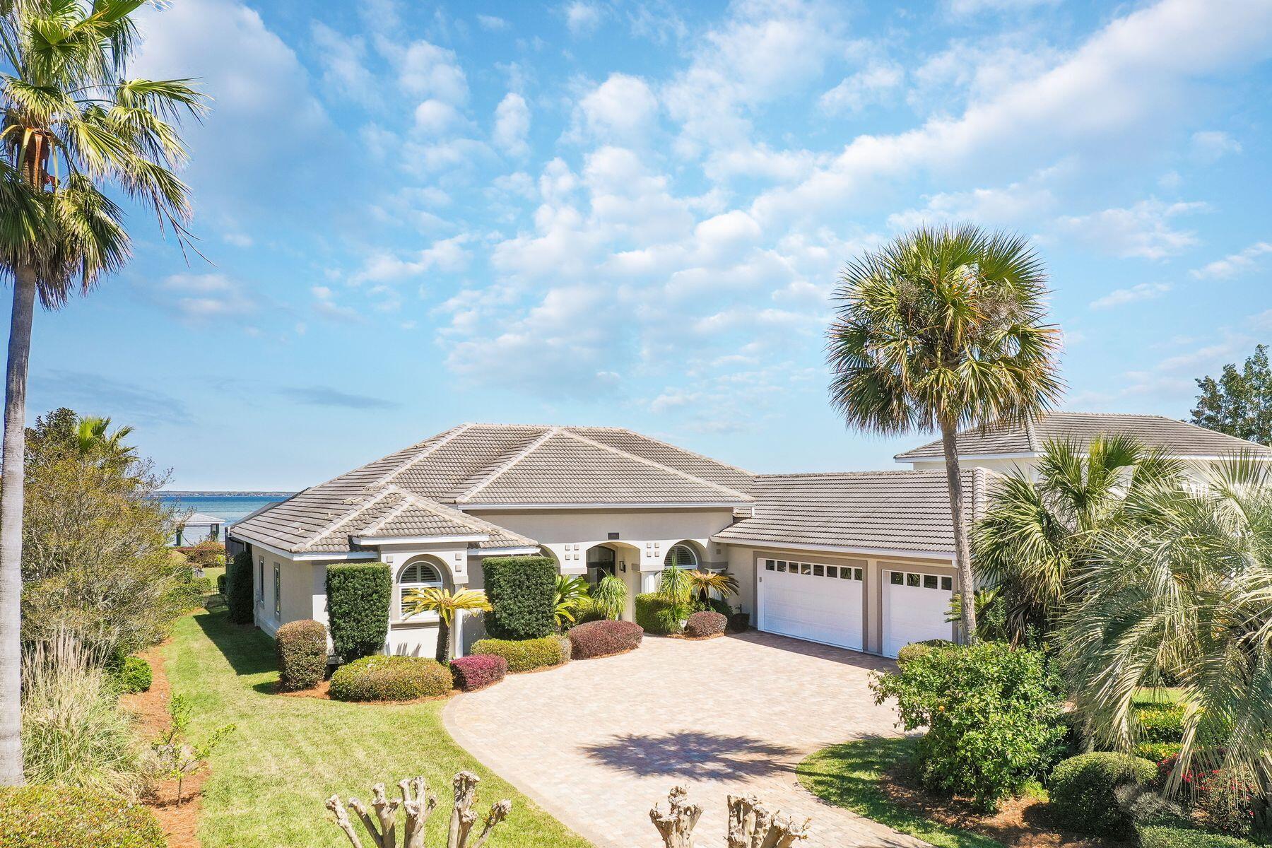 Encapsulating more than 90-pristine-feet on the Choctawhatchee Bay, this breathtakingly remastered waterfront home crafts an undeniable opportunity for contemporary coastal living and absolute privacy thanks to its seclusion within the gated community of Emerald Bay. Each detail of the interior has been hand selected to craft a stunning experience within the more than 3,000 square foot home including waterfall Calcutta Ultra quartz countertops in the chef's kitchen, shiplap walls throughout the living spaces and wide plank flooring in the living, kitchen, and bedrooms areas. Re-crafting the interior spaces in order to create an optimal single level floor plan, the new open concept layout invigorates the modernity of the compound style home, offering four full bedrooms, three full