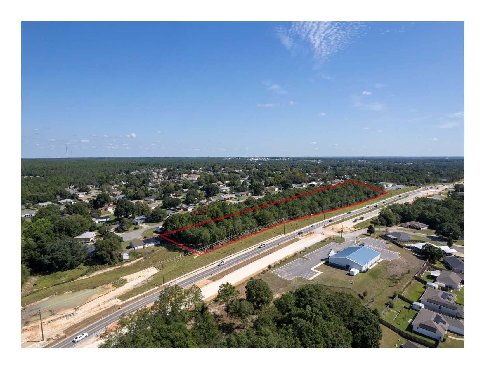 Wooded 4 acres of C-1 Commercial in the City Limits of Crestview. Adjoins new Dollar General. Ingress/Egress Easement thru Dollar General to access stop light intersection. 1,127 front feet on new four lane highway under construction and new Interstate 10 interchange to be constructed soon just west of site. Present daily traffic count is 19,000 cars per day but will surely increase when four lane and new I-10 interchange is completed. Property is deed restricted to some types of businesses and uses.