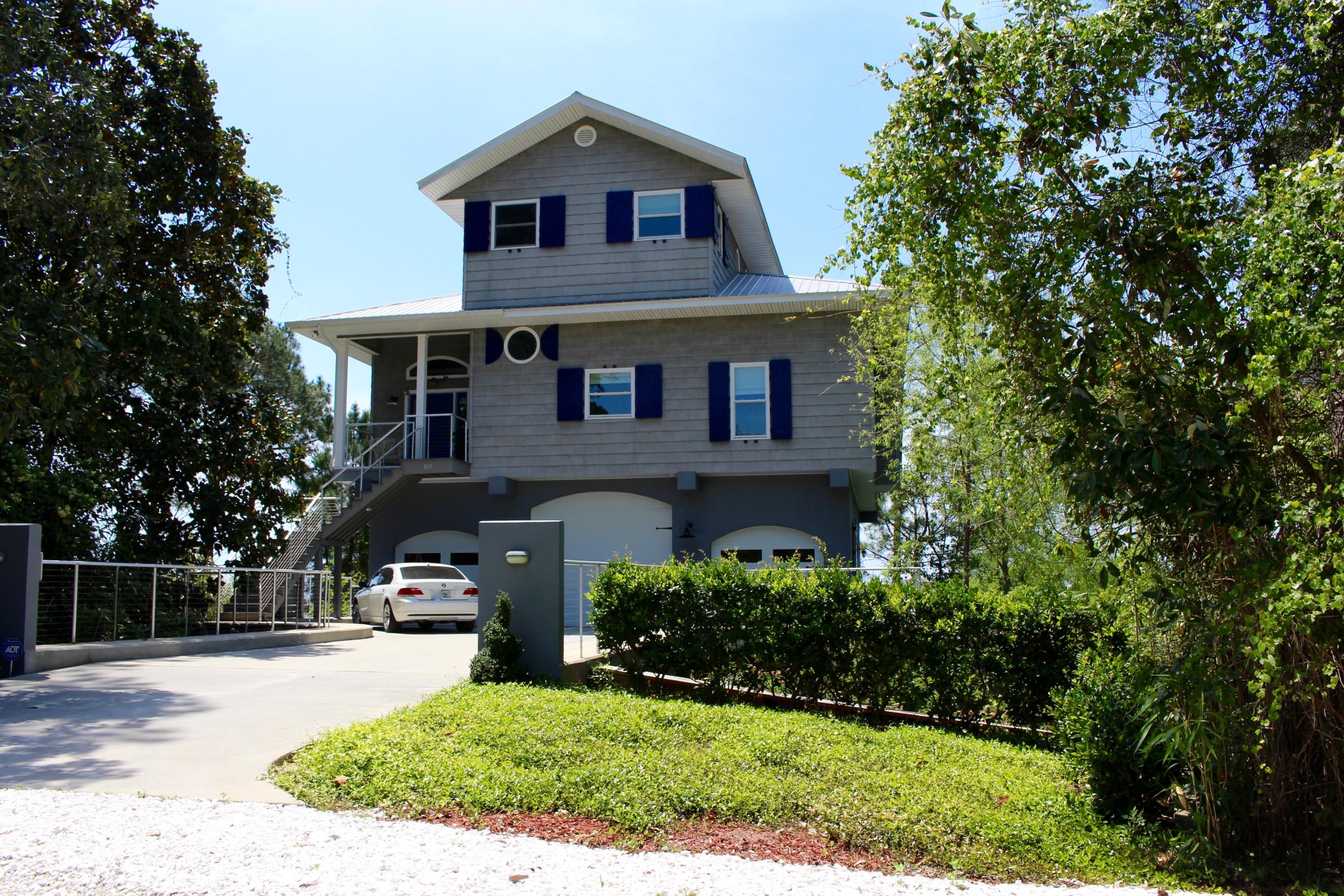 Beautiful home on Oyster Lake. Enjoy the views of the lake and Gulf of Mexico from this 3 story home with elevator. Enter from Oyster Lake Dr into your over sized garage that features 2 standard size garage doors and 1 large one for boat or RV. Full bathroom with stainless steel sink & silestone like counter top & tub / shower combination. Separate storage next to the elevator that takes you to the second floor which features 12' ceilings and solid wood, pickled stained walls and ceiling. Engineered flooring throughout. Beautifully designed river-rock stone, propane gas fireplace. As you sit in your living room, you can enjoy breathtaking views of sunsets over the horizon on the Gulf of Mexico and Oyster Lake. Open floor plan with living room, dining area and open kitchen.