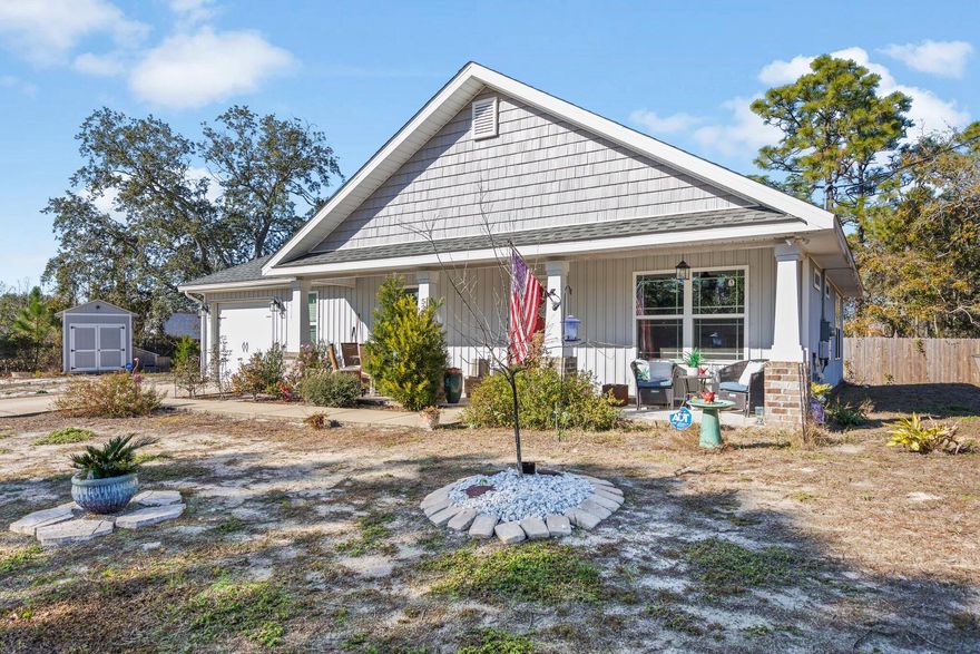 Welcome to this charming Craftsman-style home with a cozy open floor plan, large kitchen island and breakfast bar. Revel in the beauty of wood cabinets, stainless steel appliances, and premium Coretec luxury vinyl plank and porcelain tile flooring throughout. Just a mile from the Woodlawn Beach Boat Ramp located on the Santa Rosa Sound -only 5 min walk or 3 min drive! This residence offers convenience to shopping and schools and comfort.  Modern amenities include the Nest thermostat, a Ring doorbell, and a handy yard shed. Embrace the warmth of this inviting yet low maintenance haven, perfect for a peaceful and connected lifestyle.