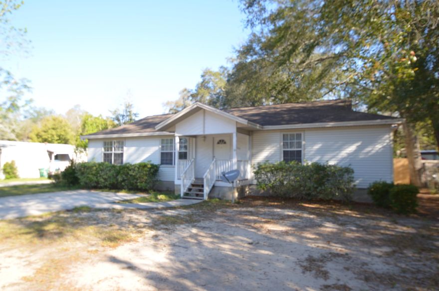 Single story 3 bedroom, 2 bath home. Tile flooring throughout with carpeted bedrooms. Open floor plan for dining/living/kitchen areas and split bedroom plan. There is plenty of kitchen cabinet/counter space, ceiling fans built-in bookcase in living room, and large walk-in closets in each bedroom. Yard is fenced in.