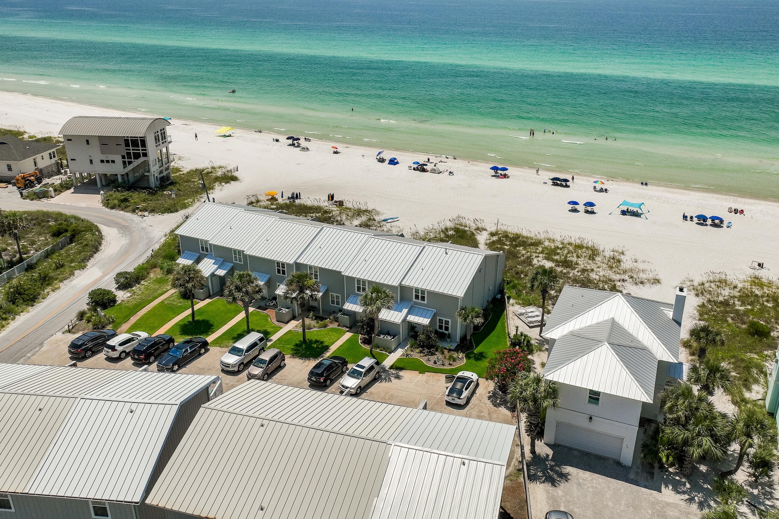 Life at the beach doesn't get much better than this! Shoreline Townhome Unit 12 is only 50 yards to the Gulf of Mexico and enjoys year-round beach access, allowing you the freedom to sit in the sand with your own chairs and tents daily. Renovated in 2021 with Gulf views from every level, this house is designed with an inviting mid-century modern feel showcasing an array of coastal colors to accent the sparkling waters of the Gulf of Mexico. The kitchen is outfitted with stainless appliances, and an oversized breakfast bar with quartz countertops which seamlessly joins the dining space for 6. Better yet why not spill out onto the covered patio and dine alfresco with your favorite bottle of Rose, while watching the sun fade off the horizon? The private master bedroom on the third floor also provides panoramic Gulf views off the private deck. And the guest bedroom has been fashioned with custom wall bunks, in addition to a separate bed, which is perfect for the in-laws or grandparents. Shoreline Townhome #12 is being sold fully furnished and move-in ready, so there's nothing left for you to do but to grab your beach gear and start living the 30A coastal life.