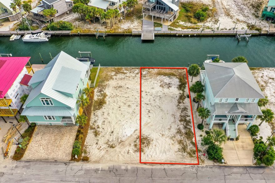 Build your dream home on this CANAL FRONT lot in the popular subdivision of Homeport.  The canal was dredged in 2021 and the bulkhead is in excellent condition.  Survey? DONE!  Soil Boring? DONE!  Plans? DONE! Designs can provide views of the sound and the gulf.  You are 100' from accessing the private beach on the sound where you can go fishing, swimming, paddle boarding or kayaking.  There is a community pool with bathrooms and picnic tables.  Short golf cart ride to the public beach access on the Gulf of Mexico. Don't miss out on a rare opportunity to own a canal lot ready for a boat and one of the few opportunities left to build on Navarre Beach.