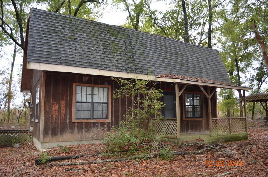 This unique REO home was built in 1987 and has all wood siding, open front porch, detached storage and 2 stories. Bottom floor consists of living room and kitchen, while upstairs you will find sleeping quarters. Nestled on right at 2.5 acres, this home is country living at it's best. This home is located on a dirt road which can be sandy at times. Please take this into consideration with visiting the home. Call today to set up your showing!