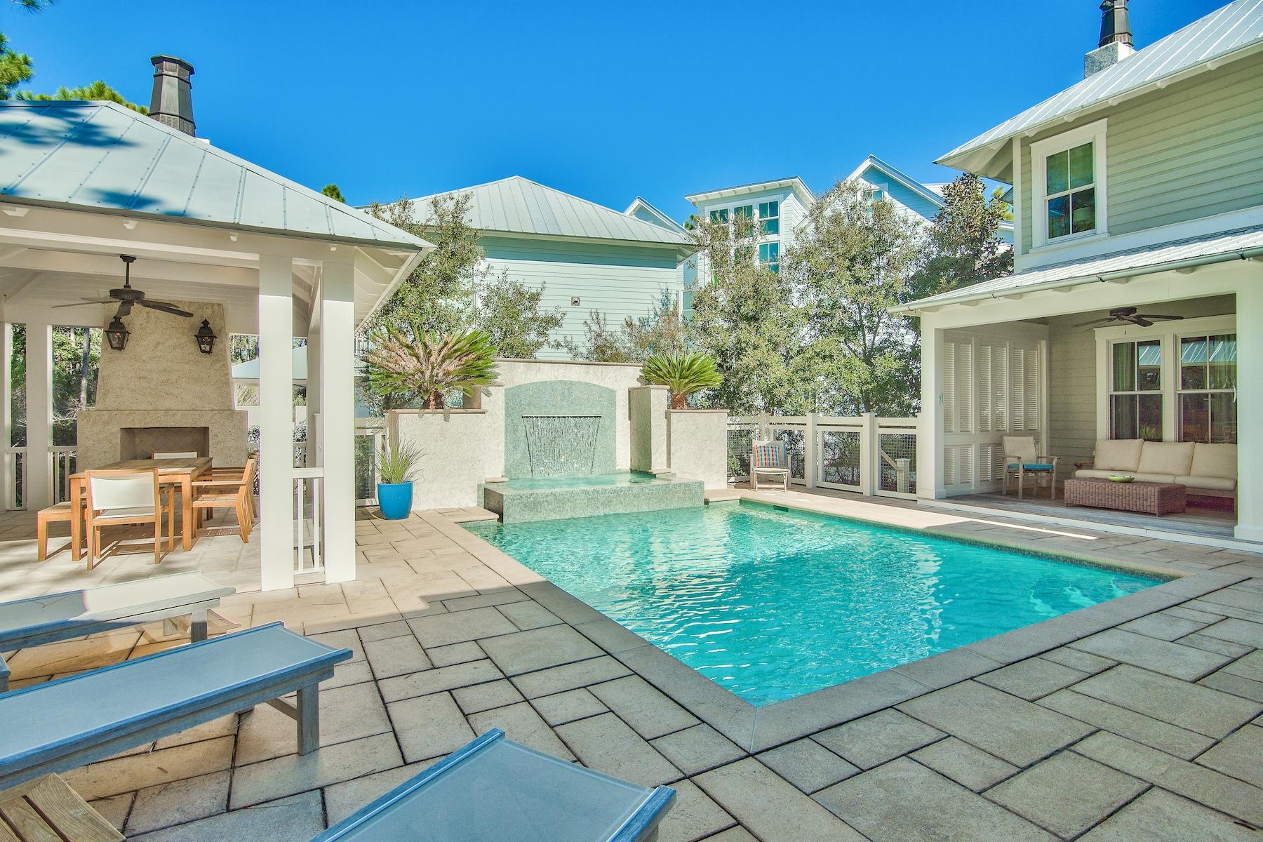 Offering what is, undoubtedly, one of the best outdoor spaces in Watercolor, this never rented custom home on a large corner lot in Phase II boasts nearly 4,000 square feet of wide open luxury living w/ 4 bedrooms, 4.5 baths and a detached 1/1 carriage house over the 2 car garage. Thoughtfully oriented to provide maximum privacy, bordered by lush forever green space, the resort-like backyard features a large private pool, covered summer kitchen with gas grill and fireplace, lanai w/ multiple seating areas, and an unobstructed sundeck. Back inside, this home is replete w/ high end finishes and natural light. The first floor features a luxe eat-in kitchen, separate dining room, coveted main level master suite, a warm and inviting great room, soaring white beamed ceilings, and shiplap walls.