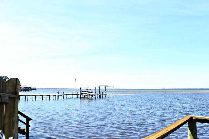 ****BAYFRONT TOWNHOME**** End Unit, fenced yard and comes with a dock. Great location and Great Price for this waterfront property. You will enjoy beautiful views of the Bay or a short drive to our amazing white sandy beaches. Get your boat, kayak or Yolo Board and hit the water. This townhome would be perfect for any style family or investor looking for a great rental. Located minutes down the road from Silver Sands Outlet Mall, Destin Commons, and many amazing restaurants.