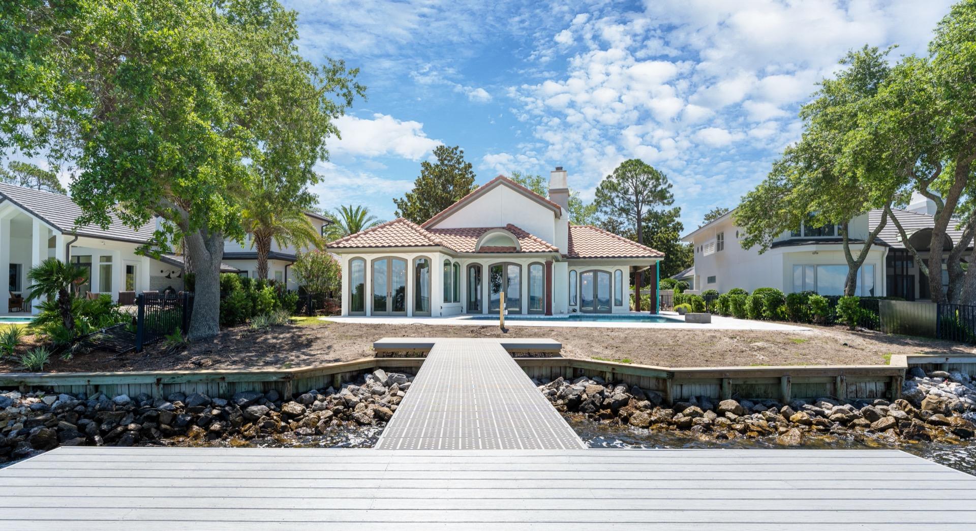 RARE BAYFRONT FLORIDA COTTAGE IN BURNT PINE AT SANDESTIN GOLF & BEACH RESORT. THIS 4 BEDROOM PLUS BUNKROOM HAS IT ALL.GREAT WESTERN EXPOSURE FOR SPECTACULAR SUNSETS EVERY NIGHT. HOME HAS BEEN TOTALLY RENOVATED IN 2018 INSIDE AND OUT.THIS 1 STORY HOME WITH AN OPEN FLOOR PLAN HAS VAULTED CEINGS IN THE FOYER AND MAIN LIVING AND KITCHEN AREAS. A LARGE KITCHEN ISLAND IS PERFECT FOR ENTERTAINING. KITCHEN HAS TOP OF THE LINE STAINLESS APPLIANCES. CUSTOM FIREPLACE IN THE LIVING ROOM.Back of the House is a Wall of Windows to Enjoy the Fabulous Views.ALL 4 BEDROOMS HAVE THEIR OWN PRIVATE BATH. POOL HAS  RECENTLY BEEN RENOVATED , A NEW DOCK ADDED, AND NEW LANDSCAPING. Weekly Landscaping included in Bay Villas Home Owners Association.