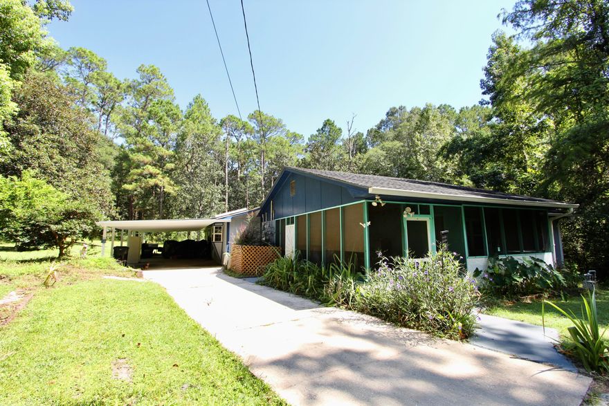 Discover a unique opportunity with this spacious 2,191 square foot home situated on a private 0.82 acre lot within DeFuniak Springs city limits--just three blocks from beautiful Lake DeFuniak. This well-designed 3-bedroom, 2.5-bath home offers an open floor plan with a generously sized master suite featuring two walk-in closets, a large laundry room, and abundant storage throughout. A portion of the home, including two bedrooms and a full bath, was previously used as an apartment with its own living area, kitchen, and separate entrance off the screened porch--ideal for guests, in-laws, or easy conversion back to an income-producing unit. Tucked away at the end of a quiet dead-end street, the property spans two parcels and includes an attached 3-car carport, screened porch, open back deck, workshop, and an additional storage building. The home is equipped with a built-in whole-house Coleman generator powered by natural gas, ensuring peace of mind during outages. This property combines space, flexibility, and locationschedule your showing today!