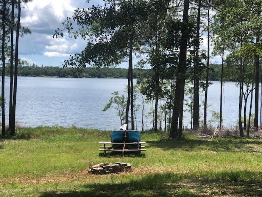 HEAR THAT?? Opportunity is knocking!Not everyday do you find a cleared lot on beautiful Spring Lake with electricity and water in place!! The owners have cleared down to the water and installed a cabin for weekend retreats. Perfect opportunity to have a ''Get Away'' or use to build the Lake Home you have dreamed about. The roads are private and maintained by homeowners in the subdivision as is the Lake.Not open to the public and only used by homeowners. Paradise within minutes of town, restricted subdivision to maintain your investment. Call today!!