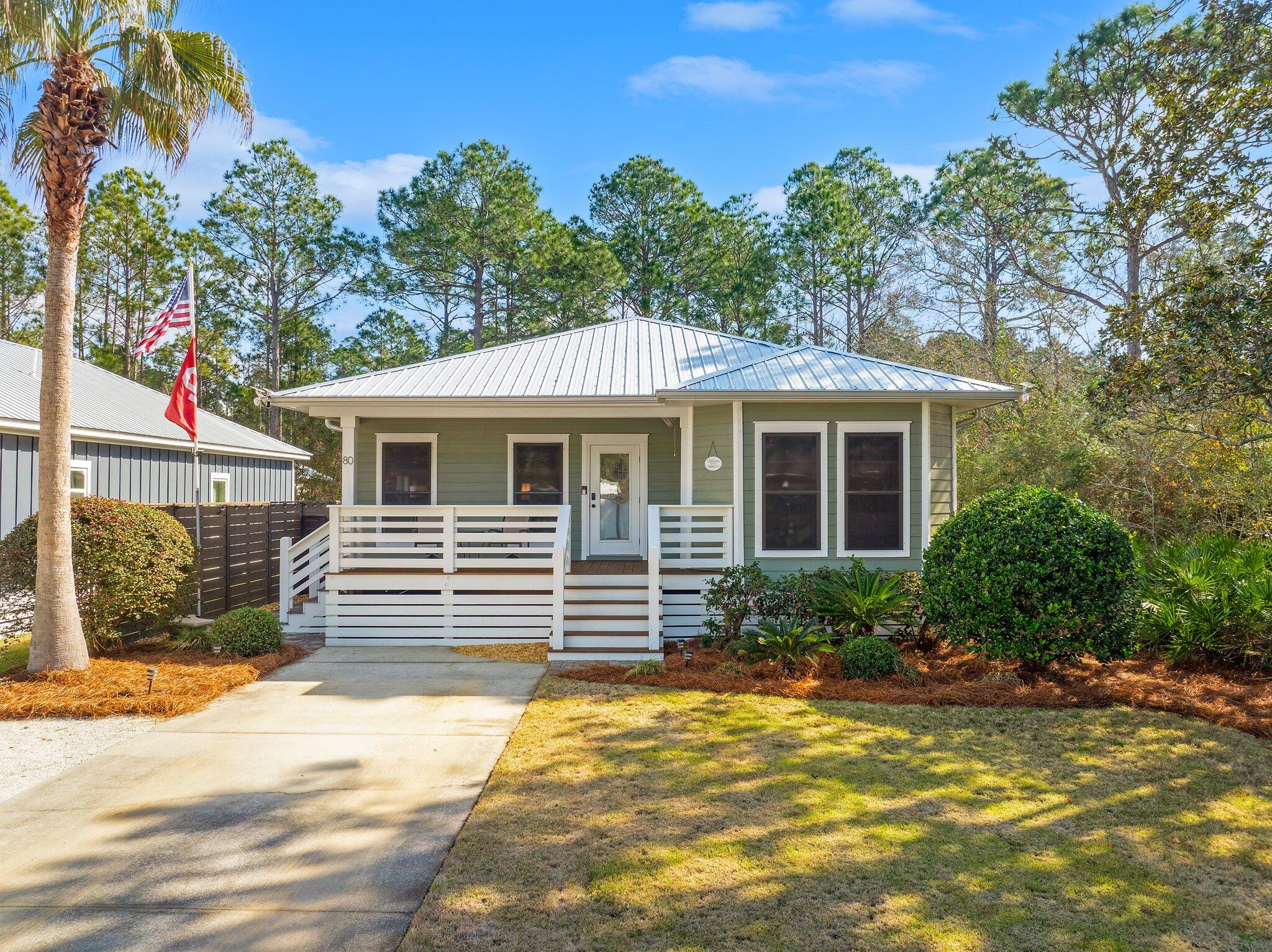 This impeccably remodeled home offers style and durability with premium upgrades. A 2023 metal roof, Trane A/C, Rheem tankless water heater, and updated appliances ensure efficiency. The exterior and interior have been newly painted. Enjoy an extended Trex front porch and screened-in back porch with cafe lighting, fans, and a V-groove ceiling. Inside, LVP flooring, craftsman trim, crown molding, shiplap accents, tray ceilings, and bamboo window treatments add charm. The kitchen features Wexford cabinets, granite, and a built-in Frigidaire Pro Series Column fridge. The master suite boasts a shiplap wall, tray ceiling, and spa-like bath. An 8-ft stained fence, outdoor shower, and storage shed complete the backyard. Just 3 miles to Ed Walline Beach Access and 1 mile to Cessna Boat Ramp.