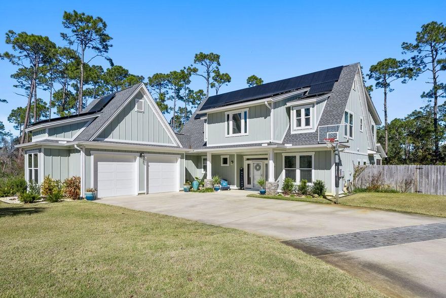 This magnificent four-bedroom property occupies a generous 0.37-acre lot with a private lagoon pool and easy-to-maintain yard surrounded by mature pines. Custom built, it offers an exceptional coastal living experience blending luxury with practicality. Solar panels provide green energy to help reduce the cost of utilities. Luxury vinyl plank flooring flows through the entire living space and bedrooms creating a seamless experience. The open-plan living room is a cozy gathering place with French doors leading out to the screened porch overlooking the alluring pool. It creates a beautiful outdoor living room in all seasons. The L-shaped kitchen continues with multiple cabinets, granite countertops, a mosaic tile backsplash and stainless steel appliances.