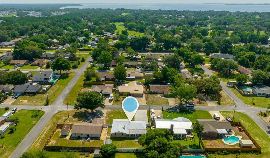 COMPLETELY RENOVATED SHALIMAR HOME NOW AVAILABLE-- AND THIS ONE IS PRICED $35,000 BELOW APPRAISED VALUE! Why, you ask? Twins are coming soon and wife says--SELL IT!Welcome to 79 11th Street! This 3 BR/2 Bath **PLUS BONUS ROOM** offers 1,706 sf of OPEN-CONCEPT DESIGN that was recently gutted, renovated, improved and perfected! Details on interior renovations momentarily--- but first let's talk exterior!Not only do you have a 40-YEAR METAL ROOF (2005), Hurricane Impact Double-Hung Windows (2015), Newer HVAC (2022), EXPANDED DELUXE-SIZED DRIVEWAY (2017), OUTDOOR GRILLING PAD WITH HOTTUB, VINYL PRIVACY FENCING (2023),... this home includes smart features and was recently equipped for FIBER INTERNET! #KeepReading #SoMuchMore Now let's talk interior renovations!

No more boxy, closed-off rooms! Instead OPEN-CONCEPT LIVING achieved, with knotty pine wood beam and recently-refurbished brick fireplace and matching knotty pine mantel. 

There's luxury vinyl plank flooring throughout much of the home, designer paint, new lighting and fixtures... as well as STRIKING GOURMET KITCHEN (2023) that the family chef will love!

The CHEF'S KITCHEN features shaker-style wood cabinetry with soft close drawers, GORGEOUS QUARTZ COUNTERS, stainless steel appliance suite, LARGE KRAUS FARM SINK (including custom attachments like cutting board and drying rack), subway tile backsplash, AND EXPANSIVE BREAKFAST BAR AREA. There's also a formal dining area, accented by hurricane impact windows that flood the space with light.

All bedrooms are spacious, with ample-sized closets, and both bathrooms were completely transformed (2023). The primary bath offers TILED SHOWER FOR 2 WITH GLASS ENCLOSURE, and features quartz vanity! The guest bath also received the royal treatment with previous owners installing new tub/shower combo, toilet, lighting and quartz vanity.

Now let's talk BONUS ROOM! This expansive heated and cooled sunroom could easily become a 4th bedroom, home office, homeschool area or play space. #YouDecide

The backyard is fully privacy-fenced (EXPENSIVE VINYL PRIVACY FENCING) with a grilling pad for backyard cookouts. The current owners use this pad for the FAMILY HOT TUB! HOTTUB WILL CONVEY WITH PURCHASE. #Freebies There's also a TRAMPOLINE, PLAYSET AND STORAGE SHED for the buyer! #MoreFreebies

Other notable mentions include SPRINKLER SYSTEM (front and back), COUNTY TAXES, and CLOSE PROXIMITY TO THE MILITARY BASE! You are also minutes away from the beaches of Okaloosa Island!

OWNER HATES TO SELL BUT CLOCK IS TICKING FOR THE TWINS ARRIVAL! Priced to move!