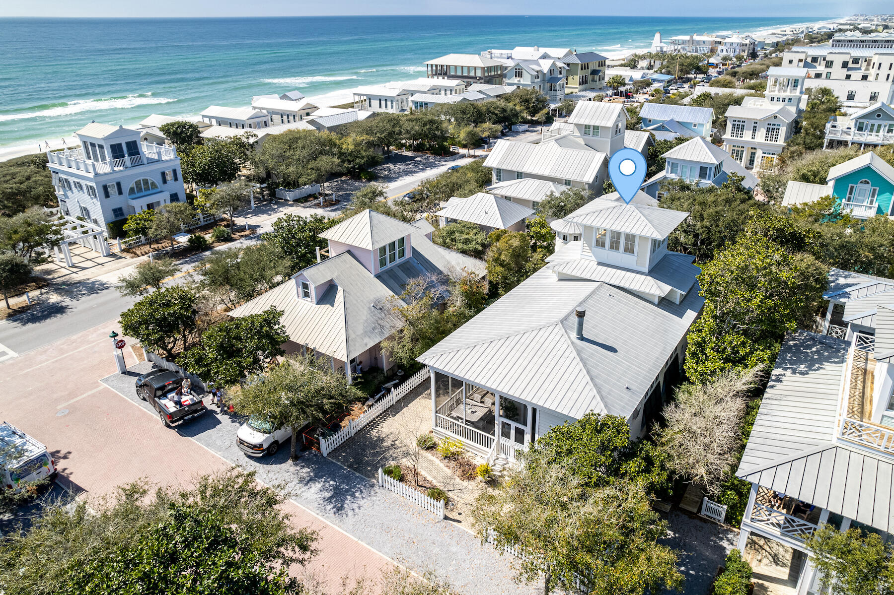 Sophisticated beach elegance at its finest. Located only two lots in from 30A, just a minute stroll to the beach. This updated southern charmer has been featured in House & Garden and Veranda magazine. Life revolves around the outdoor spaces of this beach cottage. The wrap-around screened porch is perfect for outdoor living. Step through the beautiful mahogany front door into the foyer with floor-to-ceiling bookcase. French doors with transom windows flood the living and dining areas with natural light. The home is designed for easy living; comfortable slip covered sofas and gas fireplace for chilly nights as the season starts to cool. A beautiful chandelier hangs from the 14' ceilings with crown molding. The 12' dining table seats 10 with slip covered chairs and bench seats. French doors