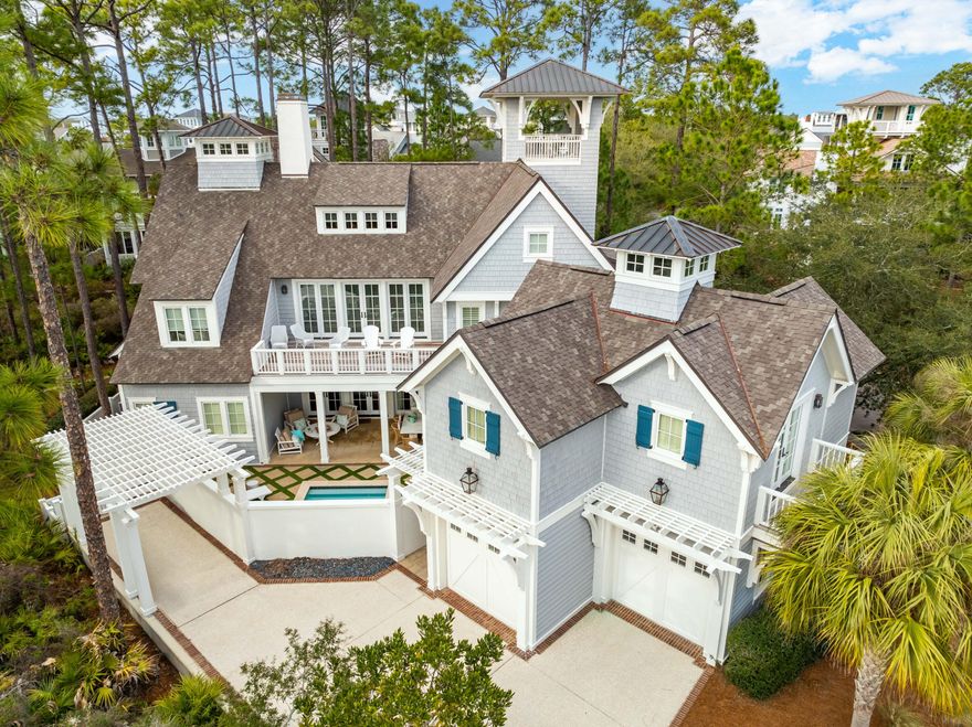 Nestled within the prestigious gulf side community of WaterSound Beach, this captivating residence, a bespoke creation by renowned Nashville architect Michael Marchetti, beckons discerning connoisseurs of luxury living. Commanding attention with its regal presence on a generous corner lot, this 6BR/6.5BA marvel with nearly 5,900 square feet astounds with a covered lookout tower, multiple covered & screened porches and an elegant courtyard with heated private pool. Every facet of this extraordinary home exudes meticulous craftsmanship and attention to detail. Hardwood, limestone, and marble floors, along with soaring ceilings harmoniously unite the array of meticulously designed spaces. Shiplap ceilings and walls paired with designer lighting give the bright and open spaces a contemporary