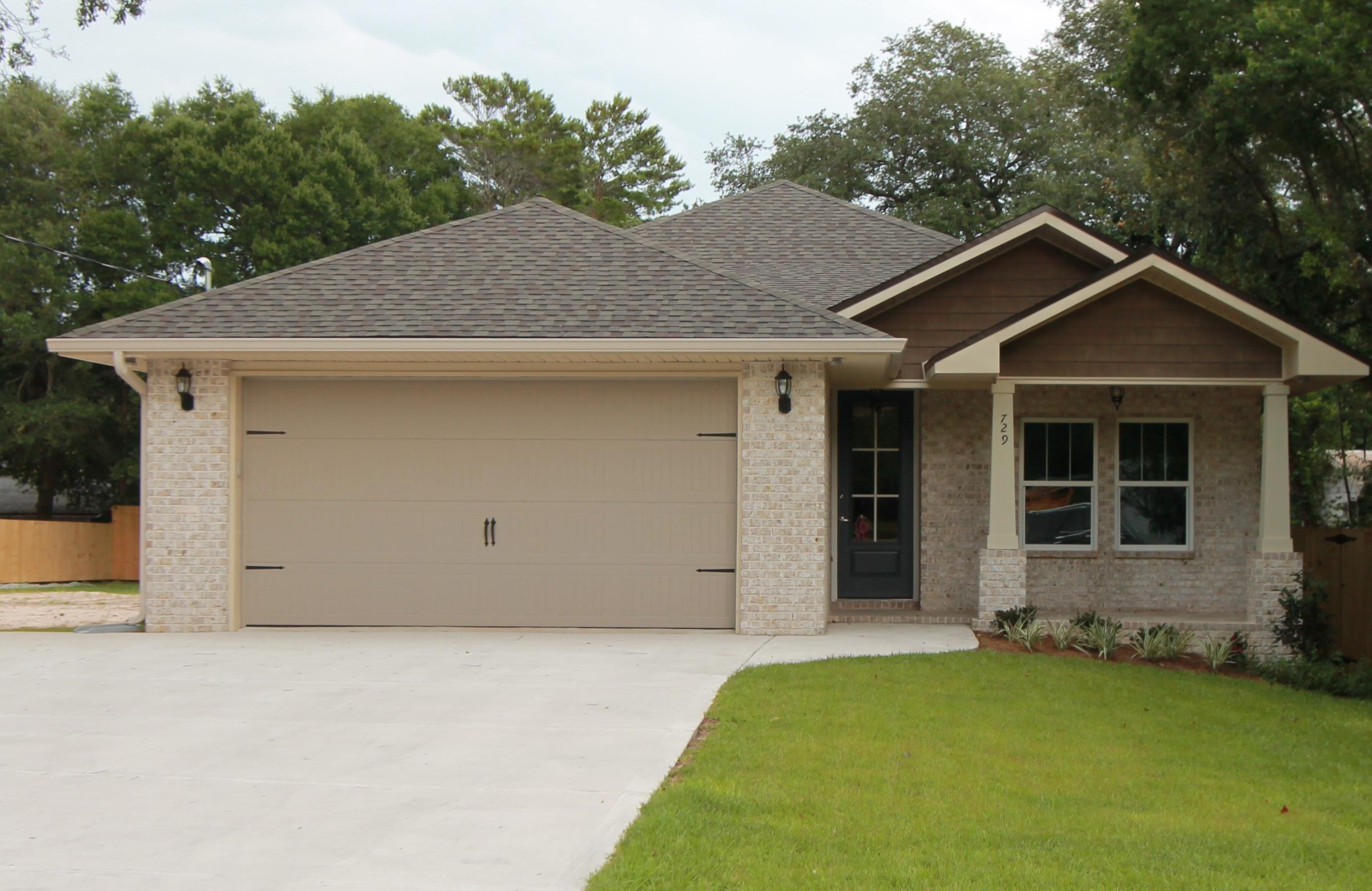 Awesome new plan! Quiet neighborhood, super close to shopping and very convinient to both bases. This 4/3 custom brick home has super curb appeal and is constructed on a large lot with beautiful mature trees. There are 10 Ft. Ceilings w/ impressive crown molding, has plank tile flooring throughout the entire home, and 5 1/4 '' baseboard. As you enter the home through the large covered porch, Bedroom 1 and bath 1 are located at the right of the home. Continuing down the hallway, you pass the huge laundry room on the left and then will enter the gourmet kitchen which boasts painted white cabinetry with ''soft close, dove tail'' drawers, above counter lighting, a tasteful combination of both Quartz and Granite countertops,