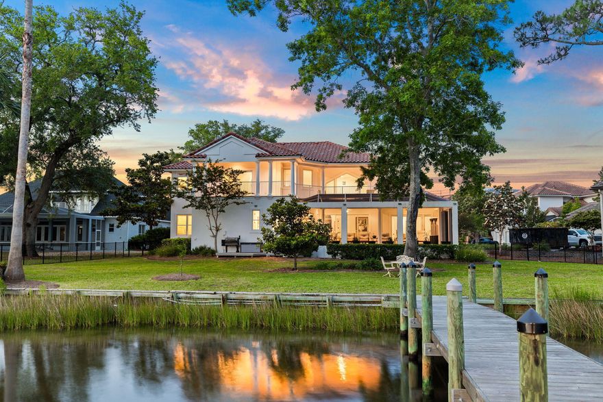 Welcome to your sanctuary nestled along the serene shores of Honeymoon Cove, a deep water bayou. This stately residence boasts 150 feet of water frontage on over 1//2 an acre  in the gated  and serene community  of Grand Cove, offering the ultimate in exclusivity and privacy. Majestic, lumbering Oak trees frame the landscape of this picturesque home, providing a stately backdrop to this elegant estate. A new dock and boat lift beckon boating and fishing enthusiasts, while a 3-car garage ensures ample space for your vehicles and toys. Entertain with ease, the soaring living room, with over 20 ft. ceiling heights and expansive design, showers in abundant natural light. An enormous limestone framed gas log fireplace extends to the ceiling serving as the focal point for chilly winter evenings.
Step inside to discover a chef's dream kitchen, complete with a 36-inch range featuring a griddle, double ovens, a warming drawer, and an ice machine.
Wine enthusiasts will enjoy a custom built wine cellar located under the stairwell, temperature controlled with well insulated 3/4" tongue and groove cedar lining.
 
Outside, a screened in lanai showcases a swimming pool that invites relaxation and leisure, perfect for soaking up the Florida sun in comfort and style.  An outdoor shower provides the perfect transition from a day of boating to the pool.
 
Retreat to the main floor master bedroom with its own fireplace  and an ensuite bathroom, offering a tranquil oasis for rest and rejuvenation. A second waterfront guest suite is also located on the 1st level.
 
Upstairs, a versatile media room awaits with a bar, and  large flat screen TV.  The area serves as the ideal space for company to kick back  with an expansive outdoor terrace boasting breathtaking views of the protected bayou, ideal for enjoying the glistening water.
 
A third  guest bedroom, complete with an ensuite bath  provides the perfect retreat for visiting family and friends, ensuring every guest feels pampered and at home.
 
This home has been beautifully maintained with many thoughtful updates and upgrades
 
Don't miss your chance to own this exceptional waterfront estate, where luxury meets tranquility in perfect harmony. Schedule your private viewing today and make this dream home yours.