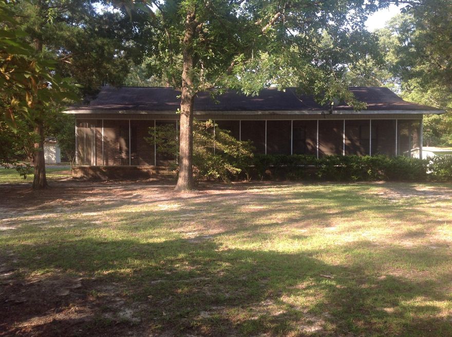 Entered for comp purposes. Brick home on nearly 3 acres with 2 beds, 1 bath and a den with built in bookshelves. Screened back porch spans length of home. Large utility room. Separate 2 car garage and storage building. In good condition ready for the new homeowner to update cosmetically (flooring, bath, kitchen, etc). Bath was designed for exceptionally tall person with extra raised vanity. Property was in an estate. Roof needs replacing in the next few years. Entire lot is chain link fenced. Cleared with large trees remaining.