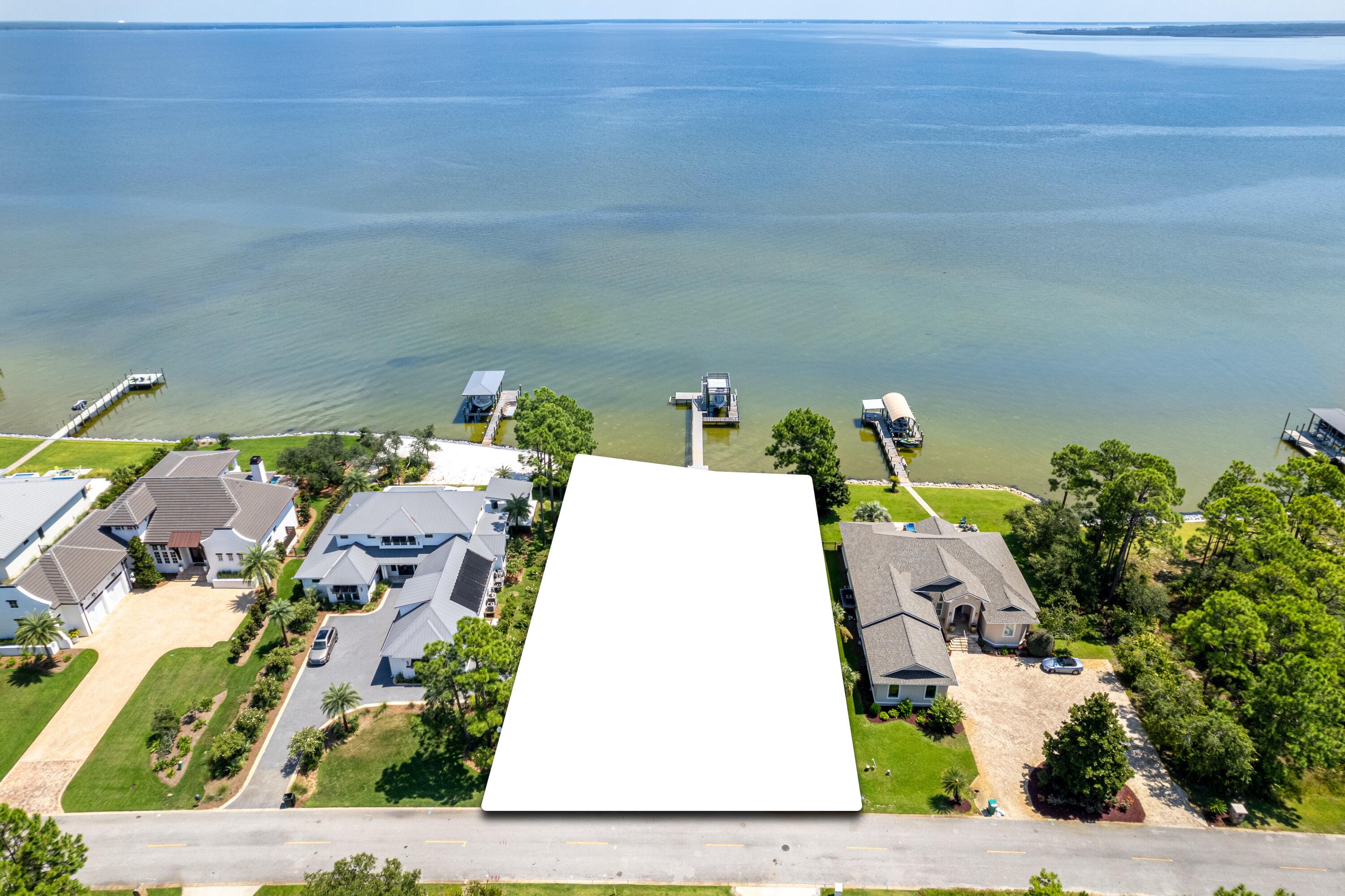 Exceptional opportunity to build a spacious retreat perched on the banks of stunning Choctawhatchee Bay. Home has been destroyed by fire and will need to be removed by the buyer. Total loss presents an incredible opportunity to purchase a rarely available vacant lot on Driftwood Pt Rd., where all eyes lead to the water. Escape to a private Oasis with 100' of bay frontage. Drive down prestigious Driftwood Point, minutes from the Emerald Coast's finest beaches, shopping, dining and entertainment yet world's away from everyday distractions. Boating is easily accessible with the recently reconstructed covered decking with deck featuring flow through decking. Low HOA costs, friendly neighbors, and pink hued sunsets. Discover life on the bay!