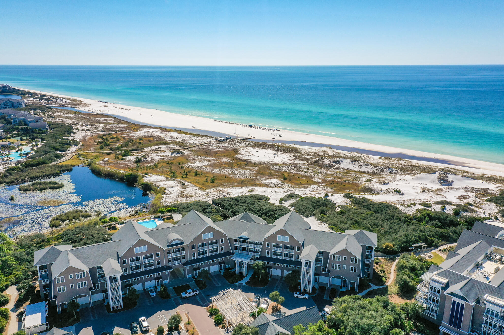 This stunning, recently remodeled and beautifully decorated coastal Nantucket style condo is 1 of only 25 condos. Architect, Graham Gund, designed and perfectly positioned it on the white sandy dunes and beaches of the Emerald Coast. This two story Gulf front condo lives large with a 1st floor single car garage, master suite with attached screened porch, a cozy bunk room and laundry room. The 2nd level has spacious living and dining areas leading to the most incredible covered porch offering stunning views. In addition there are 2 ensuite bedrooms and a office nook. Compass Pointe II captures so many details and special touches, such as antique gutters and shiplap accents and dedicated parking for golf carts and bikes.  Just a short stroll to the beach on your quaint boardwalk down to the