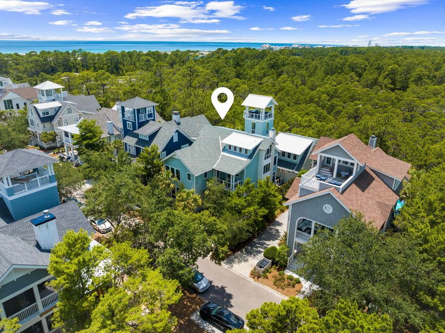 Welcome to 58 Coopersmith, a unique offering within the gated confines of Watersound Beach. Backing up to Deer Lake State Park, the location marks the perfect setting for this custom built home featuring elements not seen in its surrounding neighbors. The New England architecture blends perfectly with rustic elegance. Such features include solid hand-hewn beams accenting various areas of the home and holding center stage in the open floorplan living/dining/kitchen area, custom reclaimed wood floors throughout the home, and various ceiling and wall accents of reclaimed barn wood and pecky cypress. Truly an entertainer's dream, the main level was designed to merge indoor and outdoor living by simply opening the nano doors from the living area to the backyard oasis. There you will find a Miami inspired pool with illuminated steps and waterfalls leading to a covered patio area with outdoor kitchen, fireplace, and built-in pizza oven. Adjacent is another accordion style door opening to a game room with a ping pong table, bar with kegerator and multiple tv's along with a full bath. Barn style doors connect this room to the garage. Moving back into the main living level of the home you will find a kitchen designed for a true culinary connoisseur. An illuminated crystallo countertop showcases the kitchen island surrounded by a lavish appliance package including a Wolf 6 burner range, large Sub-Zero refrigerator, and a pantry area with an Irinox blast chiller and vacuum sealer. Adjacent to the kitchen area is an additional wet bar with a standup wine cooler. The living room is complemented by the beautiful gas fireplace and immense natural light. The main level also includes a powder room, laundry area with reclaimed barn doors, and one of the two master suites complete with an astonishing bathroom. Choose either the 3 stop elevator or the custom designed staircase to take you upstairs to the second floor where you will find another master suite, 2 guests suites, living room, powder room and wet/coffee bar. The primary suite on this floor has its own wet bar, vaulted ceilings with hand hewn beams, walk-in closet and luxurious bathroom. The 2nd floor living area leads you out to the deck connecting you to the only free-standing tower in Watersound, complete with multi-floor patio areas leading to the top where you can take in the Gulf views. Above the garage is a separate apartment area currently being used as a theatre room with electric roll down shades and projector screen. A murphy bed is integrated for those extra guests. The 3rd floor is designed for the little ones, featuring a multitude of large bunks and built-ins and topped off with an amazing bath with a reclaimed wood beam vanity. Watersound Beach offers pristine amenities and is situated in the heart of 30A. Enjoy some of the most scenic views in our area from the boardwalks leading across the preserved dune structure taking you to the large stretch of private beach.