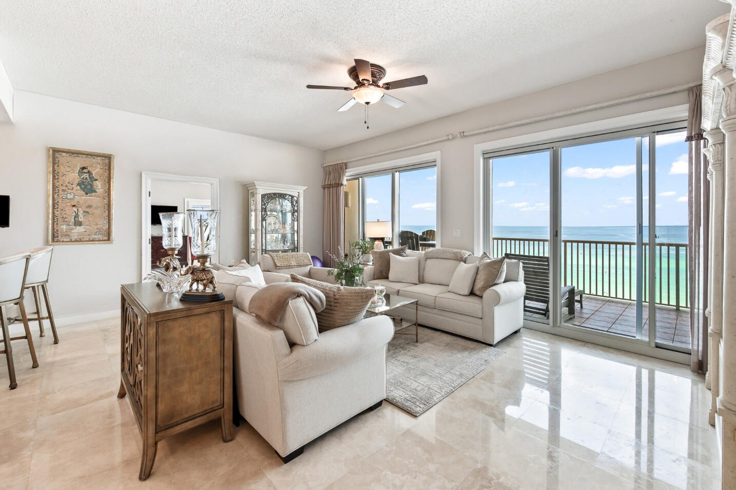 Discover paradise in this awe-inspiring 8th-floor corner unit, offering breathtaking 180-degree unobstructed beach panoramas and mesmerizing sunsets stretching from Destin to Panama City. From your expansive 50-foot balcony, indulge in the luxury of coastal living within an exclusive gated enclave.This sophisticated condominium exudes elegance with its polished travertine floors, exquisitely remodeled bathrooms, and a gourmet kitchen featuring high-end Dura Supreme ceiling-height cabinets, luxurious granite countertops, and sleek stainless steel appliances.Enjoy a unique and open floorplan designed to captivate with endless water views from every room. With soaring 10-foot ceilings and dual living areas, this home promises opulence with two master suites, each providing Gulf views,balcony access, a spacious walk-in closet in one, and in the primary master 3 walk-in closets and a relaxing steam shower.
An additional en-suite guest bedroom offers sweeping Bay views, while a second expansive north-facing terrace dazzles with pool, lake, and bay vistas perfect for al fresco dining. Adding to its allure are tasteful plantation shutters, a real gas fireplace, and the convenience of a full laundry room.
Furthermore, this condominium includes a highly-coveted, deed-assigned garage space. Truly, this property lives like a "Home on the Beach," offering a unique blend of luxury and lifestyle in an unparalleled coastal setting.
The Empress is a boutique, luxury gated community consisting of only 44 units located directly across from 2,000 feet of sugar white beaches and although 14 of the units are allowed to be vacation rentals, for most owners The Empress is a full time residence or second home. Other features that make The Empress so desirable are the semi private elevators that open into a foyer shared by only you and 1 neighbor, large climate controlled storage for each owner, a more private pool and hot tub overlooking the lake and fitness room, HALO water system, fiber optics cable, full time maintenance staff, security, and the famous Whales Tail beachfront restaurant within a block for food and beverages on the beach. Walk out the door to the beach or pool, relax on one of your balconies, or experience the great entertainment, shopping and restaurants all within a short distance. Now is the time to make your dream of living at the beach a reality. (The Empress has completed the Structural Integrity Reserve Study and passed the Milestone Inspection with flying colors with no special assessments pending!) A list of lenders that have experience in The Empress and good rates available upon request.