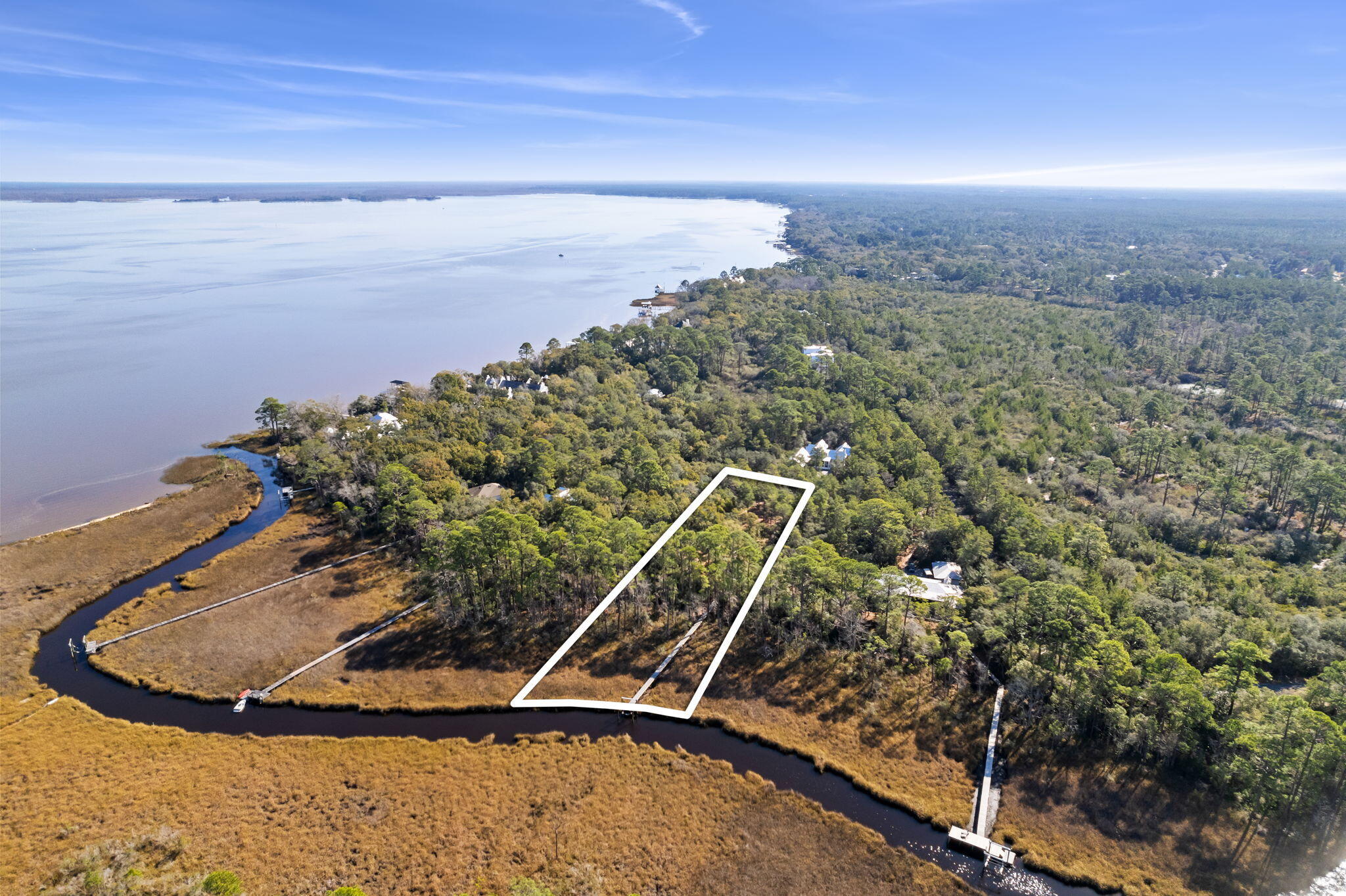 THIS PROPERTY IS UNDER CONTRACT WITH A 72-HOUR KICK OUT CLAUSE. DOCK & BOAT LIFT IN PLACE - GATED COMMUNITY - NO BUILD OUT TIME. The gated bay front community of The Estuary is the jewel of South Walton. Secluded within the Point Washington State Forest with only 39 homesites, it is unmatched in privacy and natural beauty. This one acre estate size lot is full of old growth magnolias, pines, and oaks, but yet only 10 minutes away from historic Grayton Beach and 30A. Located on Bowman Bayou with 165 feet of waterfront, this lot is partially cleared with a new dock and 7,000 pound boat lift in place providing quick boat access to Choctawhatchee Bay. The lot sits in Food Zone X with NO BUILD OUT TIME.