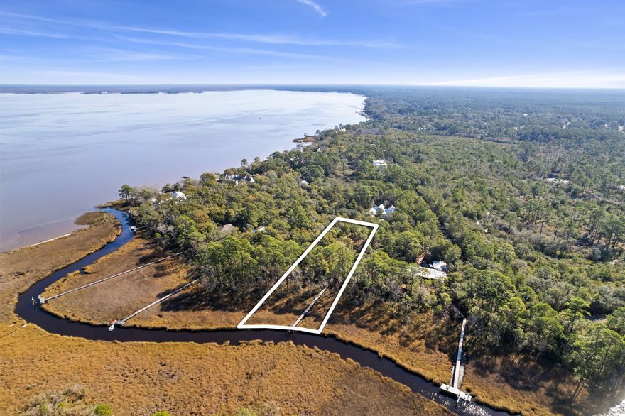 THIS PROPERTY IS UNDER CONTRACT WITH A 72-HOUR KICK OUT CLAUSE.  DOCK & BOAT LIFT IN PLACE - GATED COMMUNITY - NO BUILD OUT TIME. The gated bay front community of The Estuary is the jewel of South Walton. Secluded within the Point Washington State Forest with only 39 homesites, it is unmatched in privacy and natural beauty. This one acre estate size lot is full of old growth magnolias, pines, and oaks,  but yet only 10 minutes away from historic Grayton Beach and 30A. Located on Bowman Bayou with 165 feet of waterfront, this lot is partially cleared with a new dock and 7,000 pound boat lift in place providing quick boat access to Choctawhatchee Bay. The lot sits in Food Zone X with NO BUILD OUT TIME.