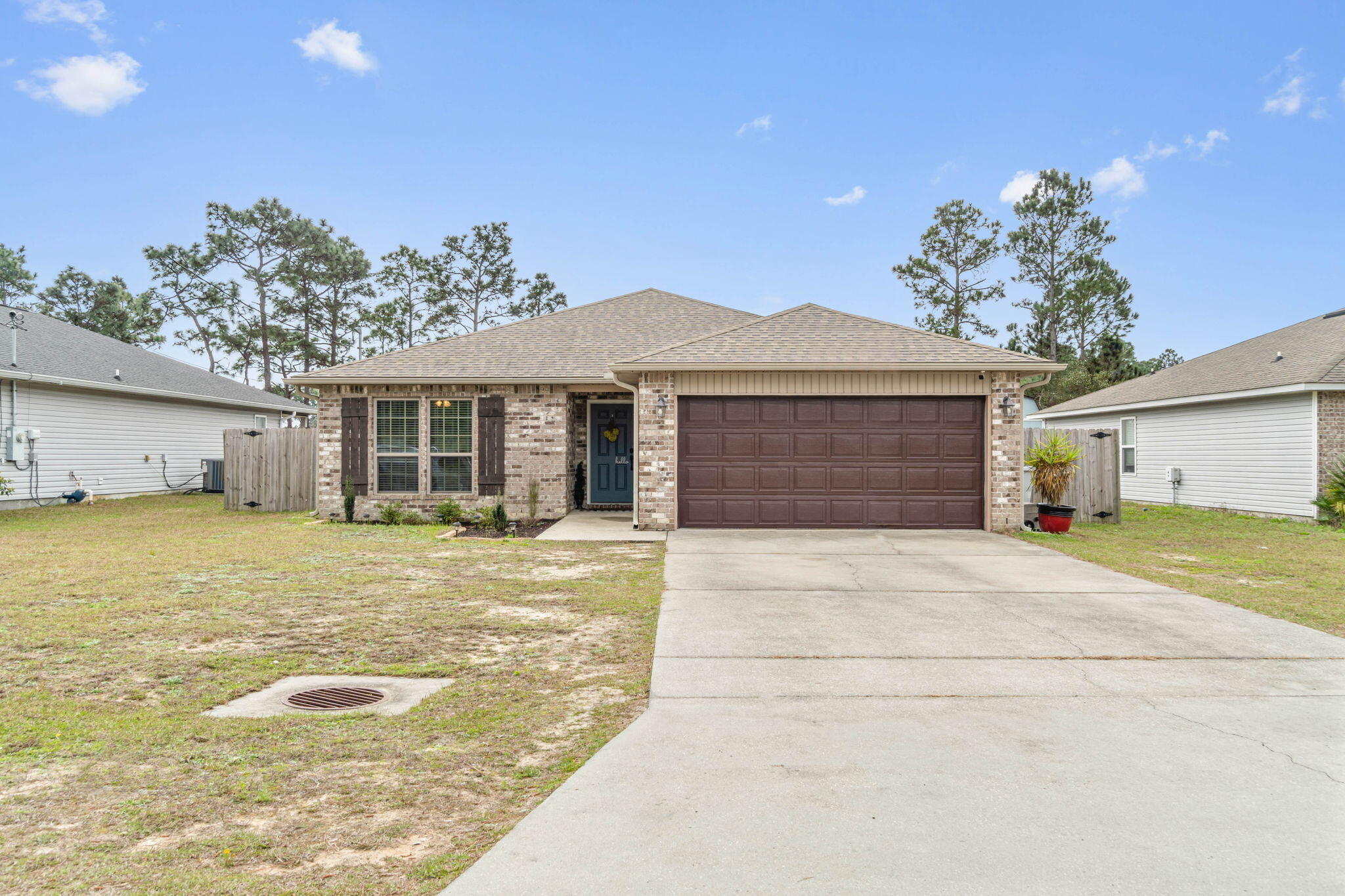 Welcome home to this charming open layout home with a fantastic backyard to entertain in! Built in 2015 and conveniently located minutes to shopping and Navarre's gorgeous white sandy beaches, you'll love this 3 bedroom, 2 bath home with no HOA. Pull into the driveway and enter inside to find a large living space with a vaulted ceiling and newly installed luxury vinyl plank flooring throughout! The kitchen features granite counters with a 17'' raised breakfast bar, walk in pantry, and stainless steel appliances. The separate dining area has sliding glass doors that enter into the covered back patio that's been beautifully extended within the fully fenced in backyard to include a fantastic entertaining area with a 16x26 paver patio, custom paver BBQ (grill will convey!), a 10x12 covered