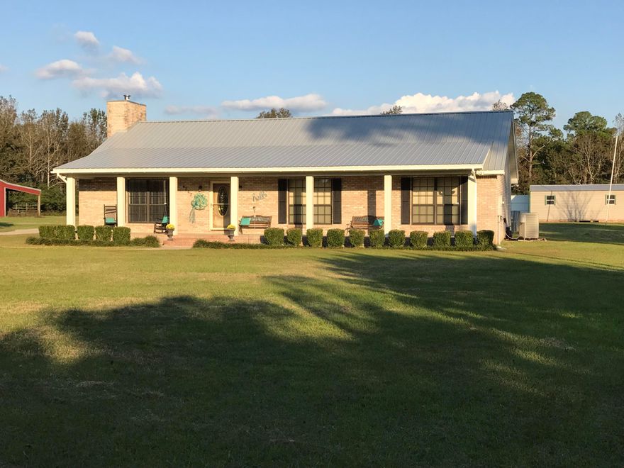 Looking for a quite country getaway? Located in beautiful North Santa Rosa County, this home would be perfect for you. Located on a quite road just off of Hwy 4, and nestled in on a full acre, this home is a must see. The Kitchen, Dining, and Living Room's boast very high ceilings and plenty of floor space. This house comes with three bedrooms and two baths. The two additional bedrooms are very spacious. The master suite is spacious as well with a large garden tub for soaking after a long day at work. The guest bathroom has a pocket door access into the oversized laundry area, which is outdoor accessible. There are power outlets located in the front soffit for easy access to power for setting up your Christmas decorations. The front porch is gorgeous, and runs the full length of the home for enjoying those peaceful evenings with the family. The workshop located in the back yard has power to make it easier to run any tools that you need. Call today for your showing of this home before it is gone. 