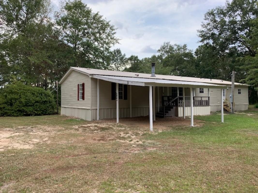 Beautifully Remodeled 3 bedroom, 2 bath mobile home, sitting on 2.18 acres of land!! Features 2 car carport and over 2100 square feet of living space. It has a spacious floor plan, cozy fireplace in the living room, new vinyl and carpet flooring throughout. Large island style kitchen with plenty of spaces for storage, brand new appliances including range, range hood, dishwasher and a fridge will be installed before closing. Also enjoy fresh interior paint, new lighting, new ceiling fans, and a brand NEW HVAC SYSTEM. Centrally located in Baker FL, about 2.5 mile north from US-90. See it today!!!