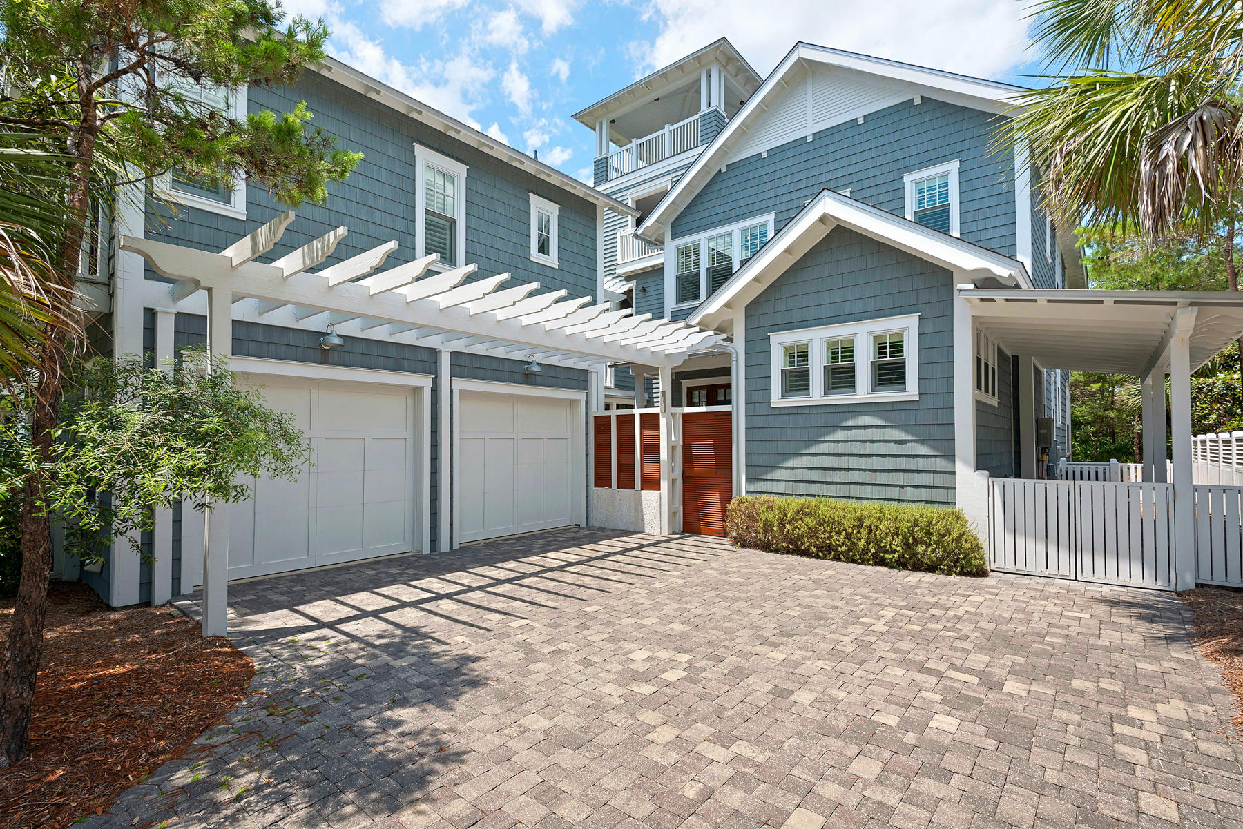 Enjoy the best of coastal living in this custom-construction, room-for-all beach house! Never rented, the home is ready to move into. Beach access is a short walk and a golf cart, included with sale, makes the trip even easier. On a corner lot, the house fronts a community park. Exterior features include two-car garage with carriage house above that is connected to the main house; private courtyard where an outdoor kitchen could be added if desired; enclosed outside shower; wide front porch; screened side porch with gas fireplace that has a soaring chimney of tabby; upstairs, a screened balcony; outdoor bar area; and open tower room for Gulf views. Decking is Brazilian hardwoods for worry-free wear. Inside flooring is stained, reclaimed heart of pine in living areas and bedroom