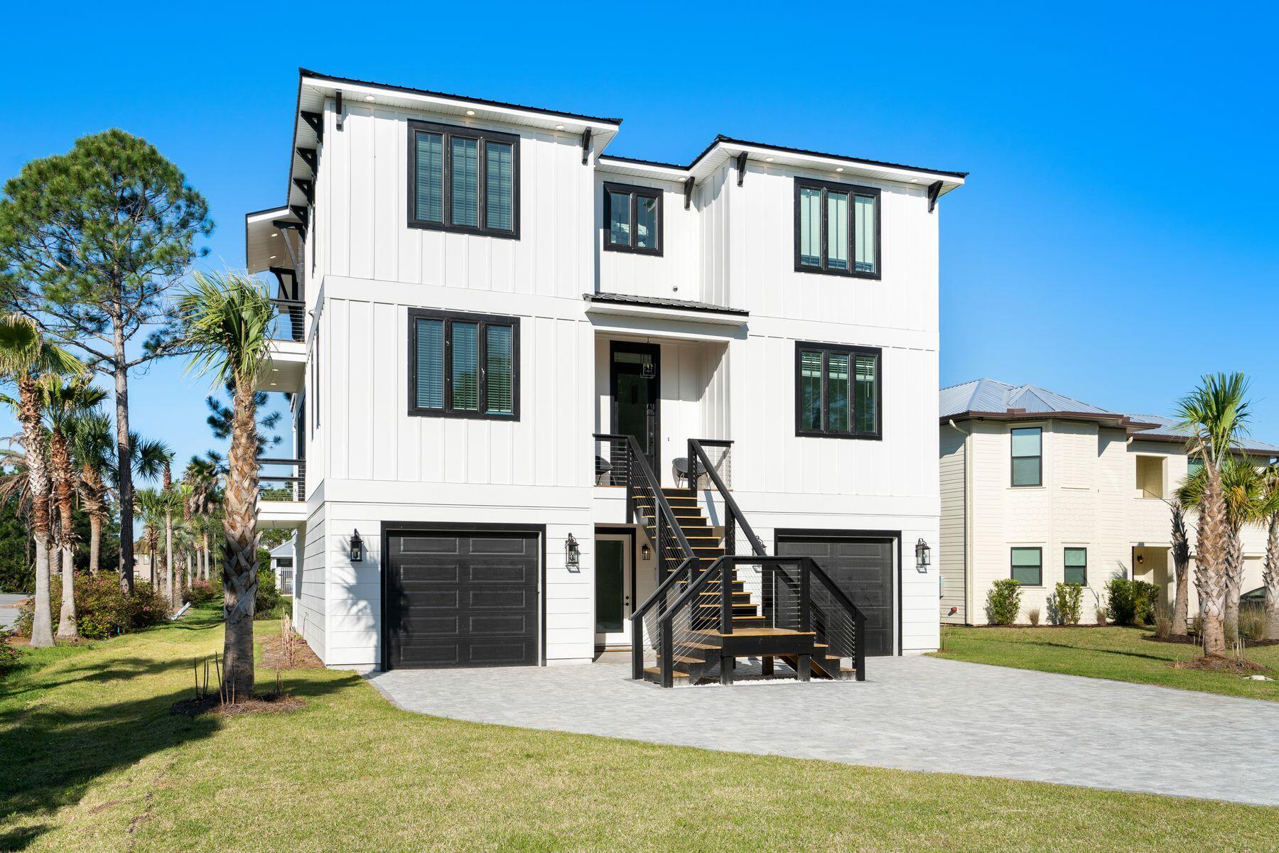 This new construction three-story home in Cypress Breeze Plantation is right across the street from the gorgeous community pool. Rental revenue projection at $175K -$200K. With six bedrooms, five-and-one-half baths, and two living rooms, it offers all the space you need for a primary home or spacious rental investment. Two separate garages provide ample storage for kayaks, bicycles, boats and beach toys. From the broad paved driveway, the classic plantation-home-style double staircase leads to the second-floor entrance with an optional entrance on the ground floor. Each level of this bespoke home has its own outdoor space with deep patios and porches providing private quiet space for guests and family members. Tile floors grace the first two levels with wood effect flooring elsewhere.