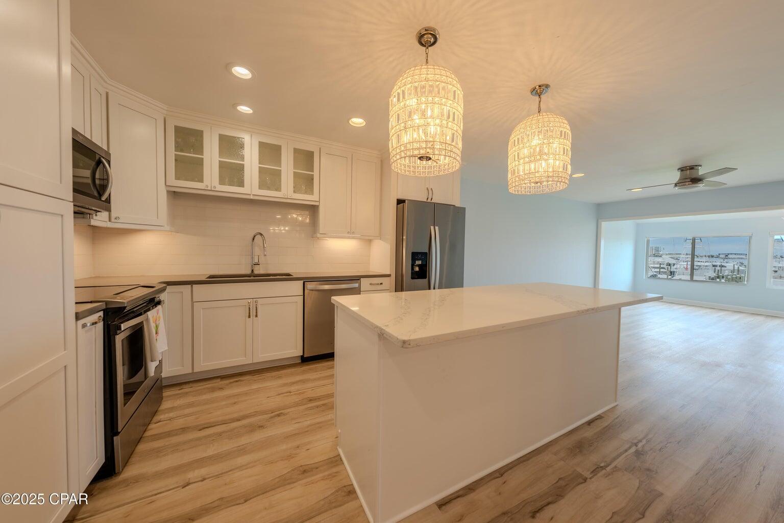 Stunning Bay Point Harbour Villa with direct views of the bay and marina from living and bedroom. The kitchen features a large island, new cabinets, quartz counters, stainless appliances, and designer lighting. Throughout the condo are LVP floors, fresh paint, recessed lighting, slicked ceilings, updated fans, fixtures, and hardware. The building itself was recently remodeled with new windows, doors, and roofs since Michael. These units can be rented short term and feature some of the lowest condo fees to be found. Bay Point is a gated community with 24 hour roving security, deep water Point South Marina, Nicklaus golf course, and resorts including Marriott and Hilton. Golf cart friendly neighborhood with 4 restaurants.