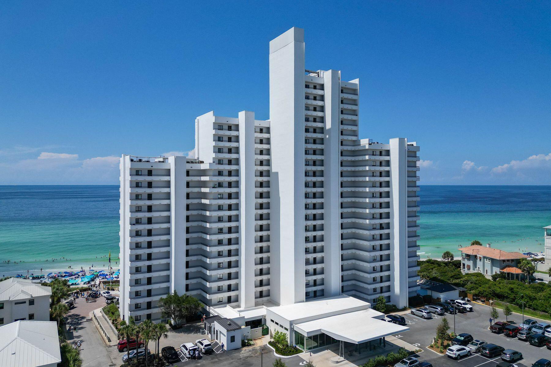 Boutique luxury abounds at this two-bed, two-bath condo at the upscale venue of One Seagrove Place. Panoramic coastal views combine with divine interiors to create this one-of-a-kind residence. Exquisitely renovated in 2023, this beachfront hideaway oozes class from each perfectly curated room. Fresh paint, bespoke lighting, custom cabinetry and new linen window treatments in the primary bedroom are just a taste of the thoughtful designer features that now grace this elegant retreat. Adding a truly tropical flavor, the Phillip Jeffries wallpaper in the open living room vies for attention with stunning gulf views framed by sliding glass doors. Step outside onto the private balcony and drink in the fresh sea air and panoramic vistas from this 20th-floor eyrie. All-new hexagonal tile flooring leads into the open kitchen, which boasts expansive Caesarstone counters along with a candy pink SMEG refrigerator and a host of refined appliances. The master bedroom offers more breathtaking gulf views to enjoy from the comforts of your bed or while sipping a cup of coffee on the adjoining balcony. Both bathrooms showcase Caesarstone vanities and fully tiled showers within all-glass enclosures. The result is a sleek contemporary finish enhanced by luxury fixtures. New lighting, new HVAC, a new water heater and many more upgrades round off this fabulous beachfront hideaway. The complex is equally outstanding with two new elevators, an updated fitness room and a community pool. A boardwalk provides direct access to the stunning white sandy beach, where you can look forward to a morning swim or a peaceful sunset stroll. A fleet of community bicycles is available for owners and guests to explore the 30A bike path leading to your favorite lunch spot in Seaside, Florida, or Rosemary Beach. For those looking for paradise, this could be the end of your search.