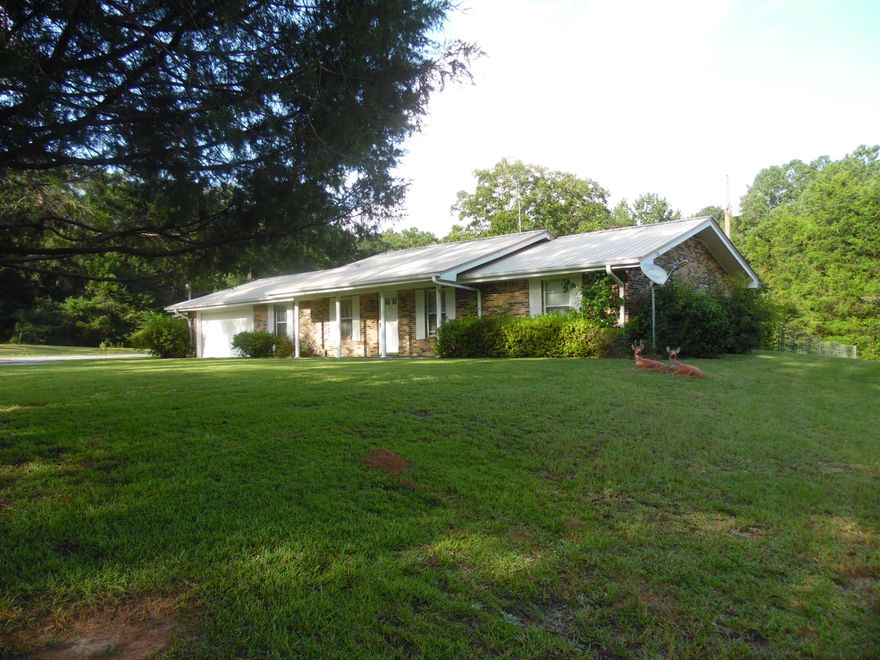 Large brick home with metal roof with a complete 2395 square footage including the double car garage on 3.4 acres. Also has two rental mobile homes that make this an income producing property ($1000/month in rental income). Home has a beautiful fireplace in the family room, formal living and dining room combo, inside utility room, 3 bedrooms and 2 baths. Call today to make an appt. to view this lovely country home located in the Bridge Creek community, less that 10 miles to DeFuniak.