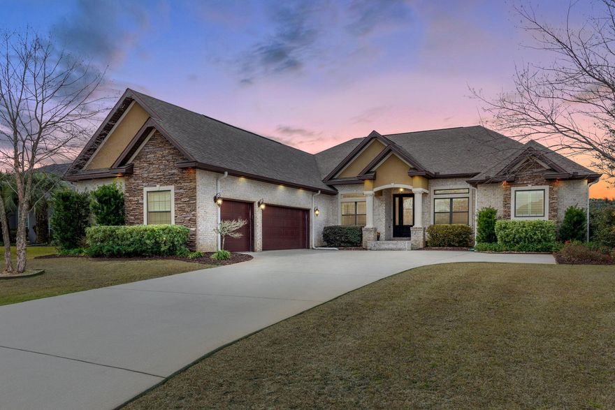 Inspiring a lifestyle of luxury and a sense of easement in the prestigious Hidden Creek Estates, one of Navarre's premier communities nestled on the 7th tee box that provides breathtaking panoramic views of the greens and overlooking lake. The exclusive community offers a wonderful social escape for avid golfers containing a #1 rated course in NW FL, Hidden Creek clubhouse as well as access to an award winning HBTS recreational center. This inclusive dream home provides an array of custom finishes that will appeal to the finest tastes. You are greeted to the residence by a thoughtful exterior containing brick and stacked stone, illuminated by custom outdoor recessed lighting that perfectly accentuates the lovely, yet dimensional detailed stonework. An impressive three car garage with convenient extended driveway, all encompassed by stunning landscaping containing regal live oak, river birches, and tropical foliage completed with columns embracing an elegant grand entryway. An exacting level of detail is seen throughout the home with particular attention paid to creating warm and inviting spaces equally suited for flow of everyday life to entertaining on a grand scale.  Head to toe refinement can be seen in every corner from the 12 ft ceilings with crown molding spanning throughout, travertine and wood plank tile flooring, custom built-ins, recessed lighting, soft-close cabinets throughout, and trey ceilings in almost every room of home. You are greeted by a large foyer that gives way into the first living space where you'll immediately notice the ample windows spanning across backside of home creating unobstructed views that celebrates the homes idyllic surroundings and allow for seamless indoor/outdoor living. The light filled; large open main living space is any entertainer's dream. The distinguished kitchen is perfect for the culinary connoisseur with its stainless steel built-in appliances, wall oven, wine fridge, abundant maple cabinetry and countertop space, gas cooktop & large island with vegetable sink, granite countertops, walk-in pantry, and sizeable kitchen bar that can seat up to eight. Off the kitchen and dinette, you will find the large, cozy family room where all your cherished moments will be made! It's complete with stylish stone floor to ceiling gas fireplace that is already recessed and wired for your big screen TV, embraced by floor to ceiling maple cabinetry, granite, and shelving, all accented by recessed lighting. The owner's suite is most like a retreat with plentiful space, privacy, and his and her closets with custom closet systems. The adjoining spa-like master bath contains his and her vanities, tiled walk-in shower with three shower heads, water closet, and large soaker tub with bordering window where you can treat yourself and feel refreshed after a long day. The two remaining bedrooms are substantially sized, have oversized closet space, ceiling fans, and complete with two full bathrooms where you will find continued tasteful finishes with one containing a double vanity sink, both having added storage, and the remaining having private access to the outdoor lanai. The remaining 4th room is most ideal and can serve many purposes as den, office, or playroom/game room. The outdoor screened living space is a noteworthy addition to this already impressive home comprising an immense picturesque sanctuary flanked by brick columns, custom lighting, three ceiling fans, equipped with gas line for grilling, and a complimentary faux wood ceiling. Revel in the best naturistic views as you enjoy the most serene surroundings, overlooking a peaceful lake that will ease the mind and soul amid the perfectly manicured grounds. A golfer's paradise, low HOA fees in regard to the amazing amenities, and true one of a kind gem in a fantastic location is awaiting new owners!  
  
The remaining curated luxury amenities this home has to offer include: Windows have solar film and upgraded 4" plantation shutters; Smart Home features-expandable home automation/security system/automated lighting controls; pre-wired for whole home audio with 5.1 surround sound; tankless hot water heater (endless hot water); extra-large mud/laundry room w/custom cabinets, sink and second refrigerator; tons of storage space; whole house water filtration system; central vac system; The 3-car garage has large garage door having wi-fi connectivity and an engineered attic space with thermal roof sheathing; and wi-fi irrigation system.
