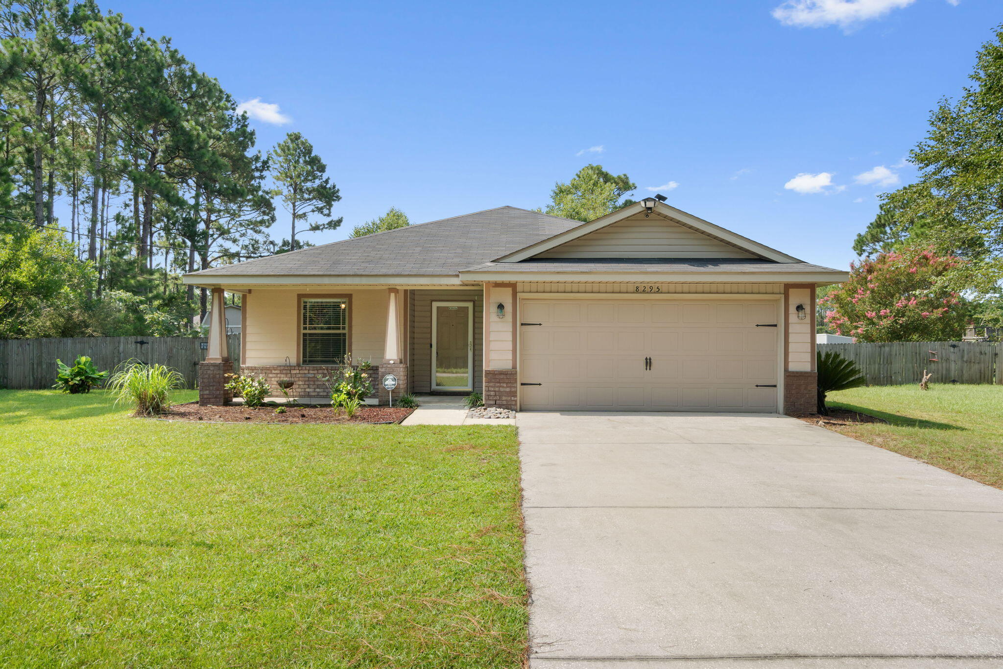 Welcome home to this adorable craftsman style 3 bedroom/2 bathroom Navarre home nestled on almost half an acre with an above ground pool just 3 miles to beautiful Navarre Beach and a short commute to Hurlburt Field! To make it even better, the Sellers will be paying off the solar panels in full at closing, so you will enjoy those energy savings!! Walk up to the front door and find a great covered porch adorned by craftsman style columns. Enter through the storm door and you'll find a fantastic split floor plan with two great sized bedrooms with ample closet space and a shared full bathroom at the front of the house through an archway, and the owner's suite at the back. Hard surface flooring extends throughout other than recently professionally cleaned carpet in the bedrooms. Walk through