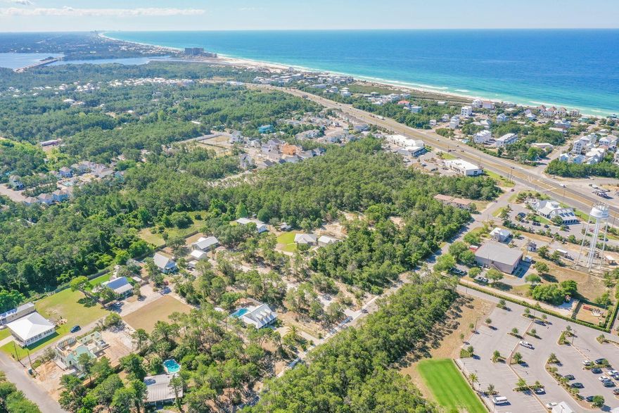 TAKING BACK UP OFFERS.... Located in Inlet Beach, this 1/3 acre lot is wooded and can accommodate a pool, carriage house and up to a 5,000 square foot home. When you own this lot you have the benefit of the quarter acre lot adjacent to the property that will never be built on. Lot 1 is located less than a half mile to the Inlet Beach public beach access and just steps away from the shops and restaurants of 30Avenue and soon to be completed pedestrian underpass. This neighborhood offers the conveniences of Rosemary without the crowds. Lake Powell public boat launch is a short two mile distance from this lot. Whether it is lake or beach living you desire both are just moments away from this unique lot. Tap fees have been paid.