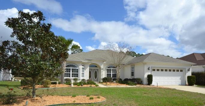 Wonderful Custom Built 4 bedroom 2.5 Bath home in sought-after Hammocks Subdivision. This Lynn Haven Home features 10'' Ceilings, Tile Flooring, Crown Molding, Arched doorway, two Electrical Fireplaces, split Floor Plan, Formal Living Room, Large Dinning Room, Solid Surface Countertops, Enormous Kitchen with Island and Walk-in Pantry. The Master Bedroom boast a huge walk-in closet, Tray Ceilings and the 2nd bedroom is accessible by a pocket door. Making it perfect for a nursery for a new born. The Master Bath includes Double Sinks, Whirlpool tub and a separate shower. The home overlooks a picturesque pond, huge screened porch to enjoy the view, built in intercom system with front porch camera, ADT Security System, wired for a built in home generator, beautiful Landscaping with automatic