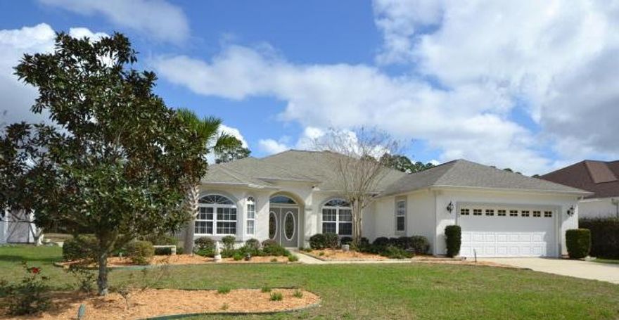 Wonderful Custom Built 4 bedroom 2.5 Bath home in sought-after Hammocks Subdivision. This Lynn Haven Home features 10'' Ceilings, Tile Flooring, Crown Molding, Arched doorway, two Electrical Fireplaces, split Floor Plan, Formal Living Room, Large Dinning Room, Solid Surface Countertops, Enormous Kitchen with Island and Walk-in Pantry. The Master Bedroom boast a huge walk-in closet, Tray Ceilings and the 2nd bedroom is accessible by a pocket door. Making it perfect for a nursery for a new born. The Master Bath includes Double Sinks, Whirlpool tub and a separate shower. The home overlooks a picturesque pond, huge screened porch to enjoy the view, built in intercom system with front porch camera, ADT Security System, wired for a built in home generator, beautiful Landscaping with automatic