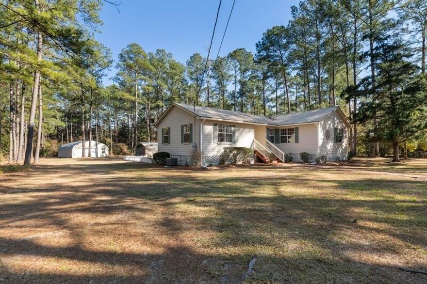 Quiet and Peaceful 2.25 acre property near the heart of Freeport, Florida with much to offer. This charming 3 bedroom 2 bathroom Florida Cottage has been well cared for. TAs you enter the home, this split floor plan offers a large living room in the center of the home. Just off the living room is a dining area that connects to the homes kitchen. As you pass the kitchen you are lead to the indoor laundry room and side exit door to the home. Continue down the hallway to the large master bedroom complete with His & Hers walk-in closets and private master bathroom. On the other side of the home you will find two more spacious bedrooms with beautiful views of the property and a full bathroom in the hallway. A sliding glass door from the living room will take you to a massive two tier deck with
