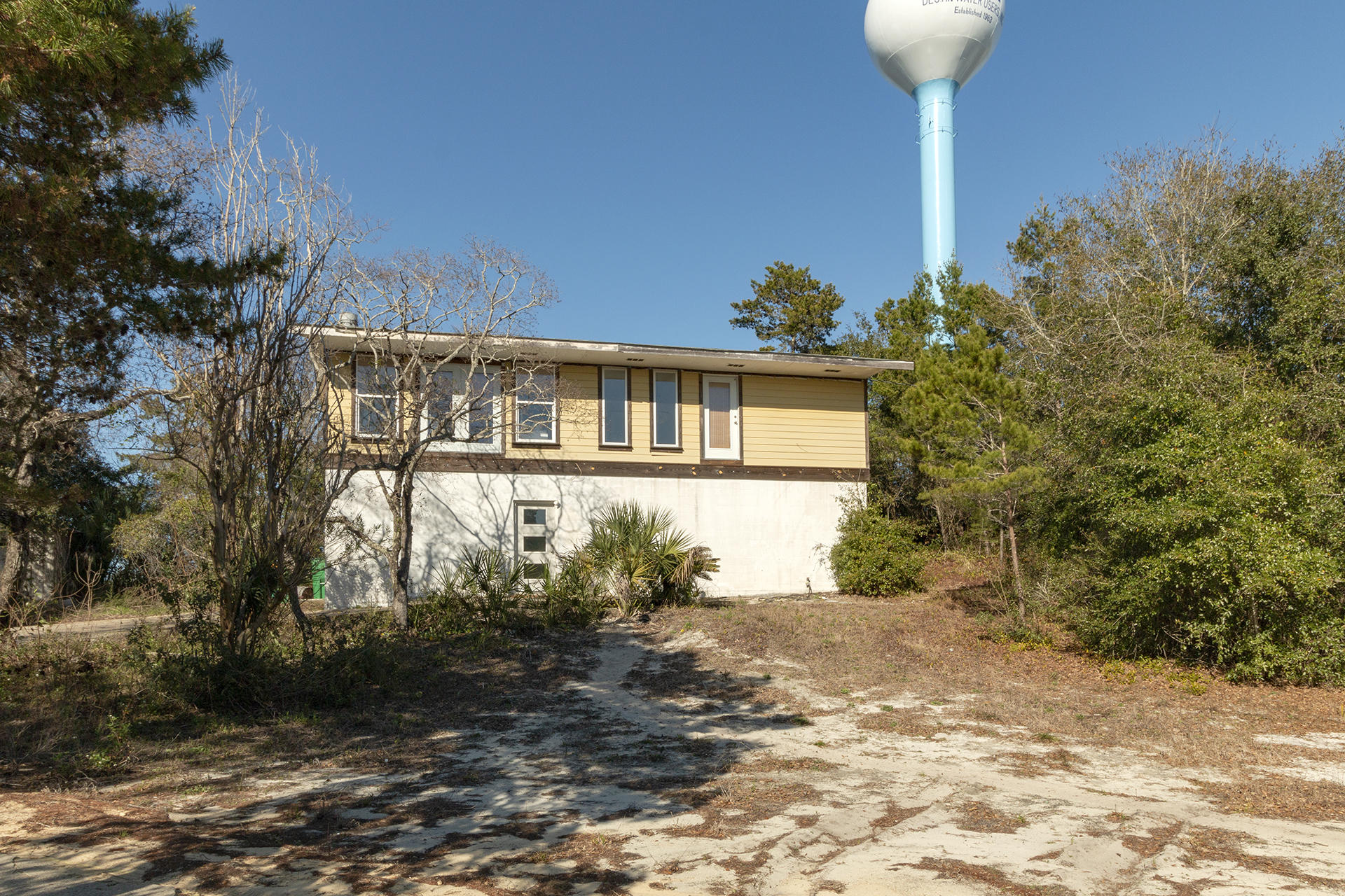 5BR/2.5BA Home on a large lot in downtown Destin with no HOA dues. This home is currently under renovations and being sold AS-IS. As you walk into the home you are greeted by a large open foyer. There are 4 Bedrooms downstairs, 2 have been completed with crown molding, new paint, & updated bathroom. Upstairs you will find a large open living space with bamboo wood flooring, shiplap ceilings & crown molding. The kitchen features granite countertops, shaker wood cabinets, & stainless appliances. Off the kitchen is a sitting area, pantry, and large dining space. The master suite is on the 2nd floor and features granite countertops, jetted tub, & separate shower. Other features include new hot water heater, new hardy board outside, & new windows throughout. Don't miss this amazing deal.
