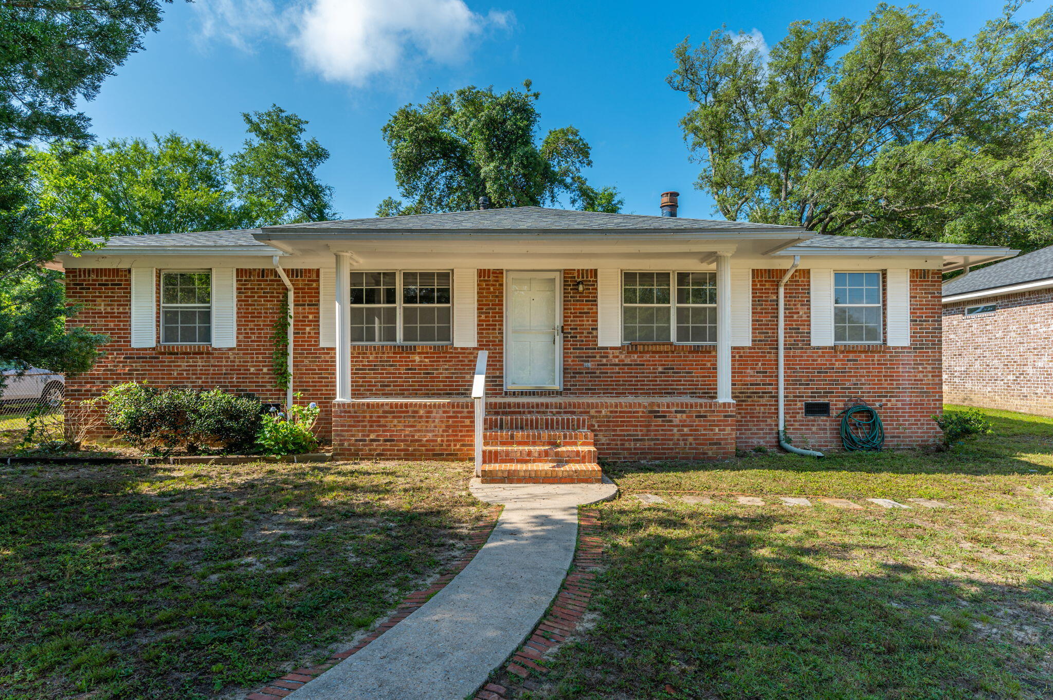 Centrally located 3 bedroom 2 bath all brick home  providing easy commute to the local bases, beaches and shopping centers. As you step inside you will right away notice the beautiful wood floors and charming fireplace. Kitchen boasts plenty of granite counter and cabinet space to meet all your cooking needs. Additional features include barn sliding doors, painted cabinets, tile floors, and subway tile backsplash. Large laundry room that also provides additional storage. Spacious deck for enjoying morning coffee as well as those summer BBQ's. Yard is fenced in providing a safe place for the kids and family dog to play in. Schedule your showing today!Roof 2020HVAC 2014