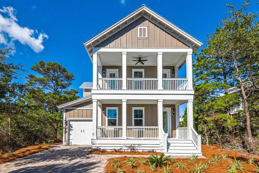 This attractive beach home is situated on one of the largest lots in sought-after Highland Parks at Blue Mountain Beach. The traditional full-width front porch provides a grand entrance to this deceptively spacious residence which includes 4 bedrooms, 4.5 baths, media room, garage and more. Newly completed in 2018, the two-story home has a Galvalume metal roof and eco-friendly tankless water heater so owners may anticipate a maintenance-free future, whether this becomes their primary residence or a well-located vacation home. The pristine interior boasts wood flooring in the main living areas with tile in the bathrooms and laundry. There's ample space for relaxing in the light and airy open-plan living room with its tray ceiling, twin fans and recessed lighting. A long breakfast bar